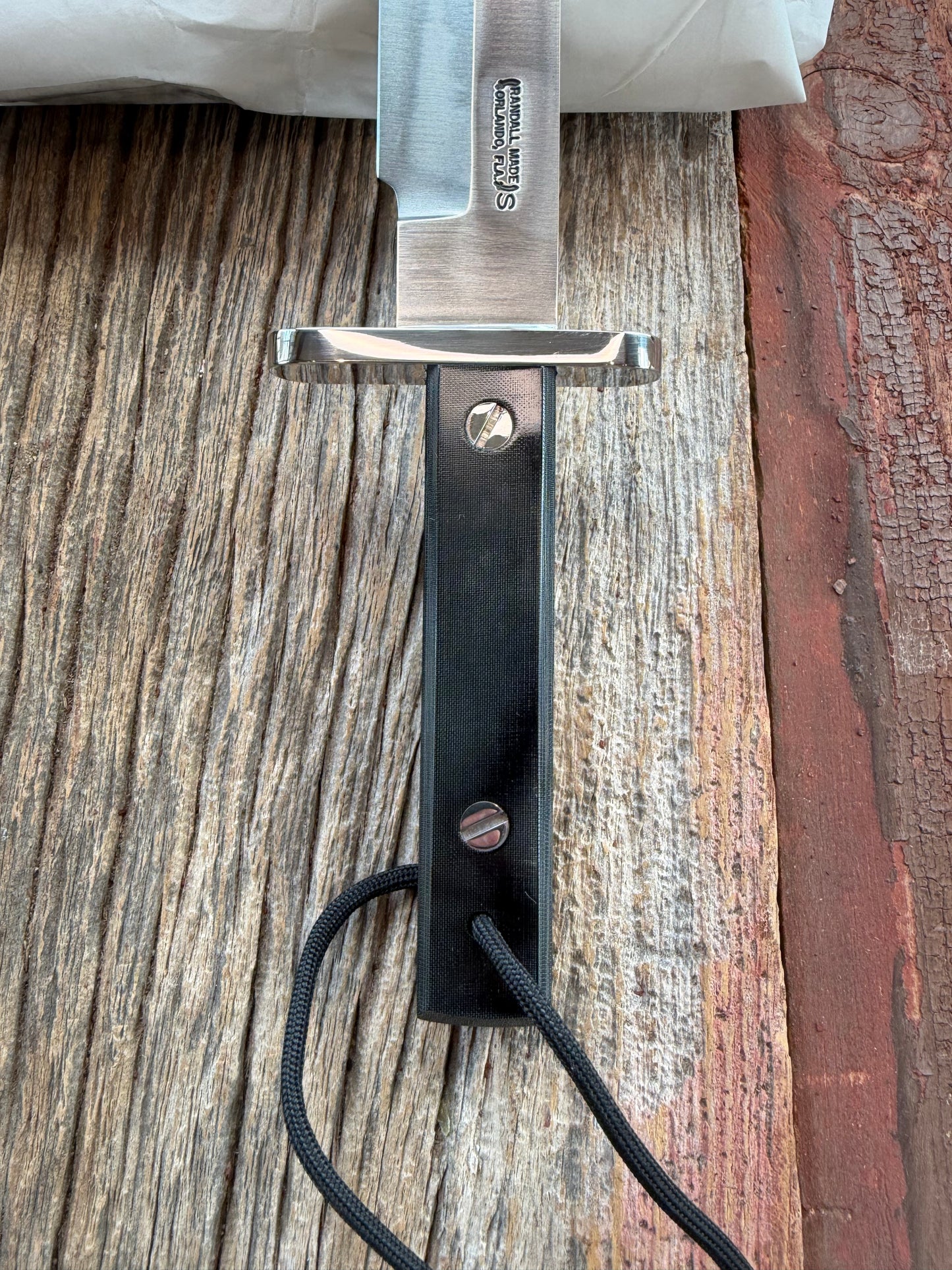 New in Paper Randall Model 17-5.5 Astro knife is a custom, handmade combat knife with a 5.5" stainless steel clip point blade and a brown leather sheath. Full tang design, black handle.