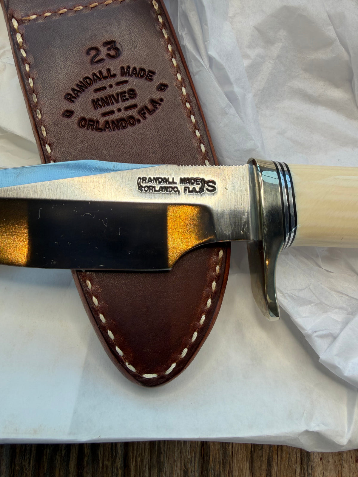 New in paper Randall Model 23 Game Master in dealer supplied Resin, Stainless steel blade, Nickel silver hilt and butt cap, Black and Aluminum spacers and Brown leather sheath.