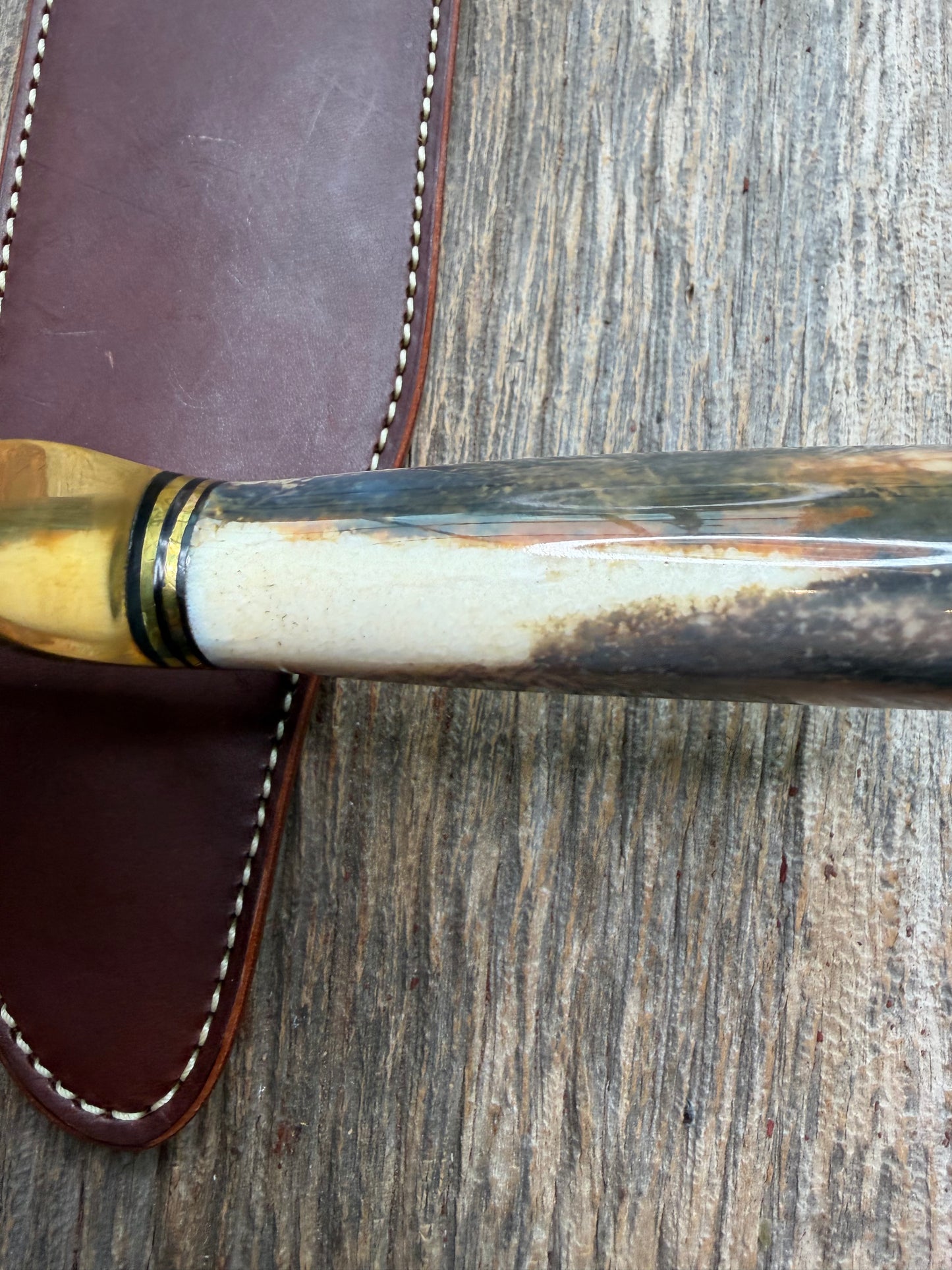 Randall Model 12-11 Smithsonian “Smitty” in a Huge piece of Green, Brown and Blue Fossil Walrus Ivory. Brass Hilt and Brass Butt plate fully engraved in Silver from Jere Davidson.  Stunning piece.
