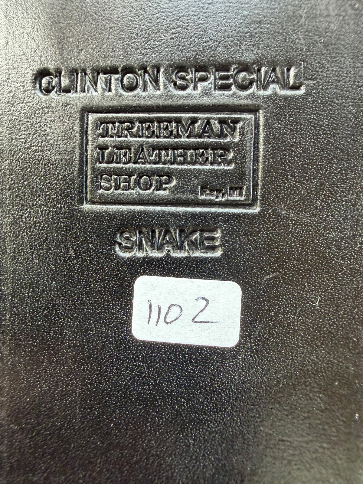Randall Model Clinton Special sheath with inlayed Western Diamondback RattleSnake skin from Treeman Sheaths. Very dark skin on brown leather, white deviated stitching and black canteen snaps.