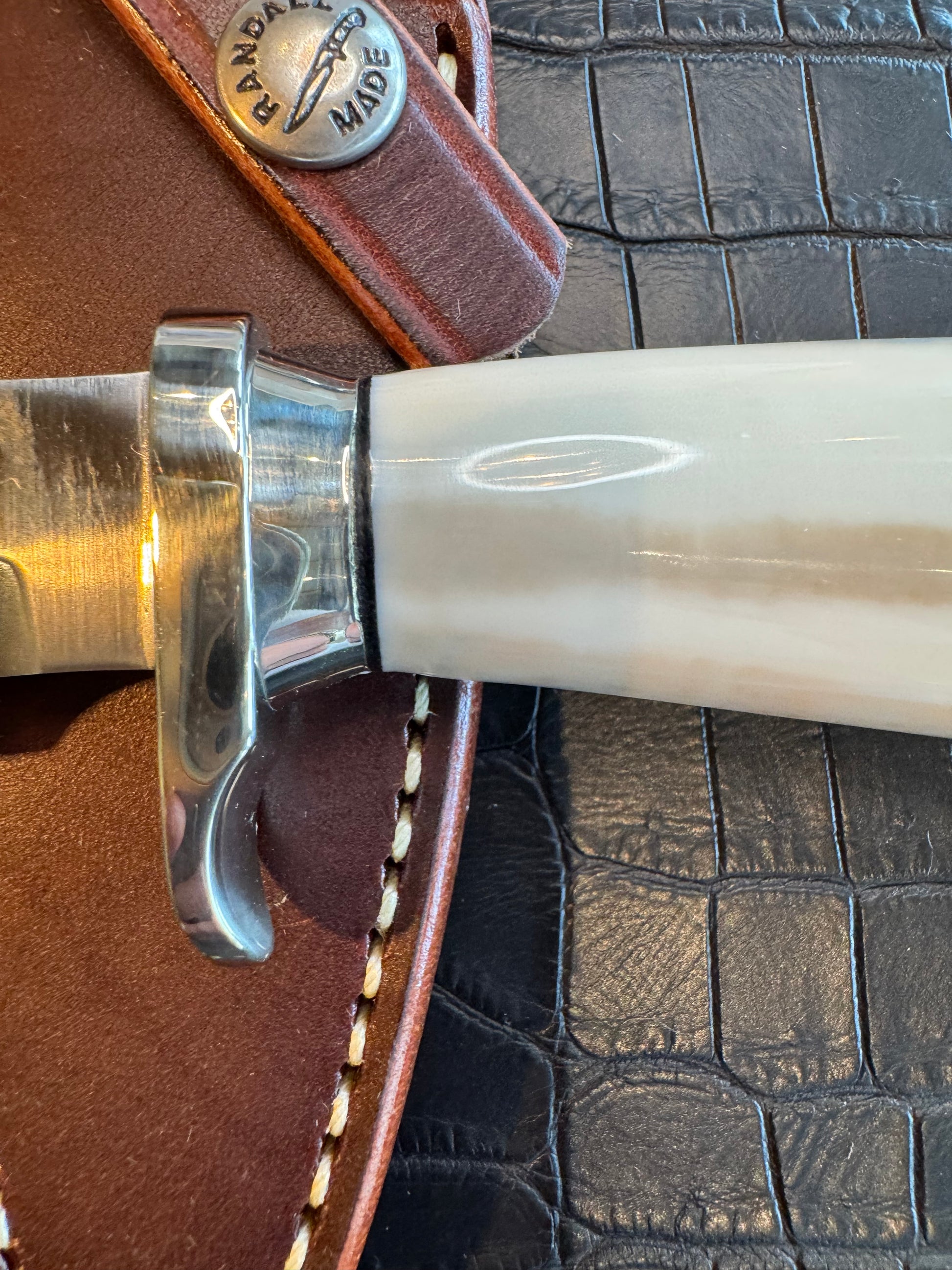 News in Paper Randall Model 8-4 in a gorgeous piece of Cream and Blue Fossil Walrus Ivory. Nickel Silver single hilt with a nickel Collar and butt cap.