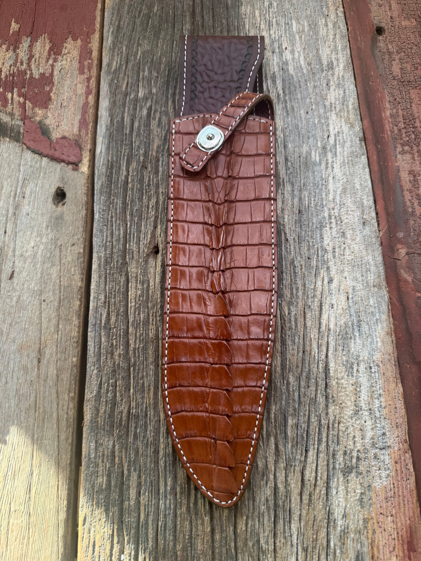New Randall Model 12-11 Large Sasquatch Sheath in Exotic thick and textured Honey Crocodile skin ( tail portion) on brown leather from Treeman with a silver Canteen snap. Hand tooled belt loop. Killer sheath.