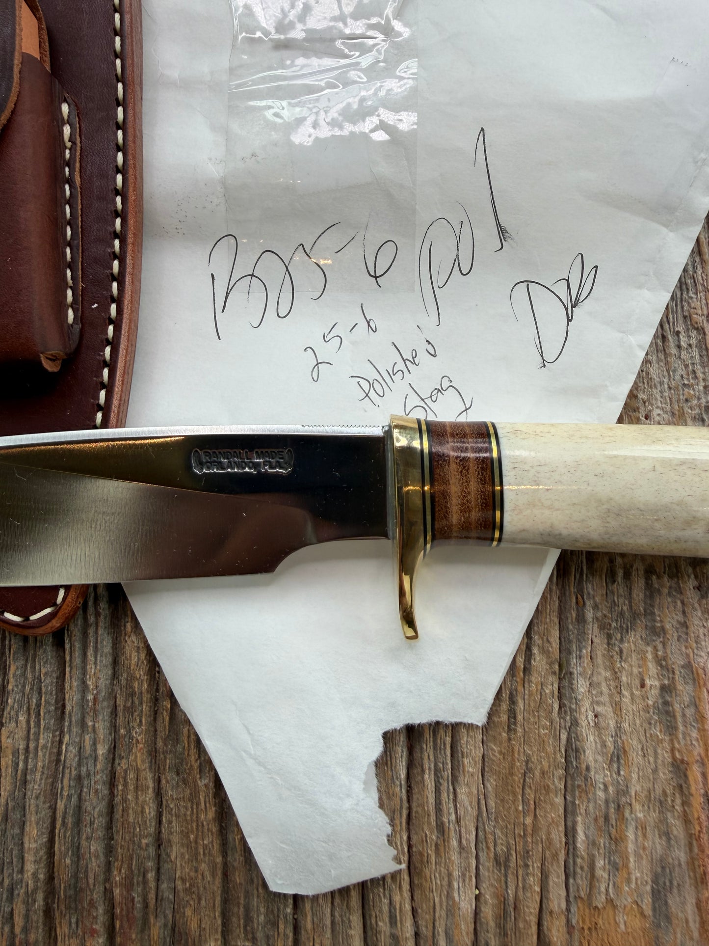New in paper Randall Knife Model 25-6 Trapper in Polished Stag Leather Handle Stainless Blade, brass Hilt