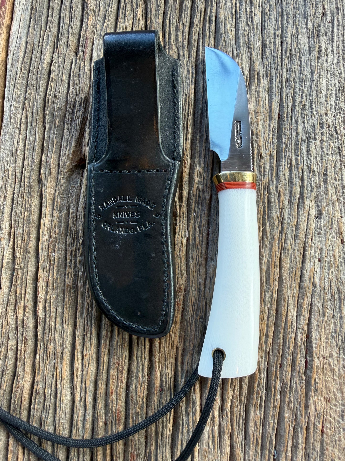 New in Paper Randall Non Catalog Model  Cattleman. White Ivorite handle. Red and silver spacers. Stainless blade.