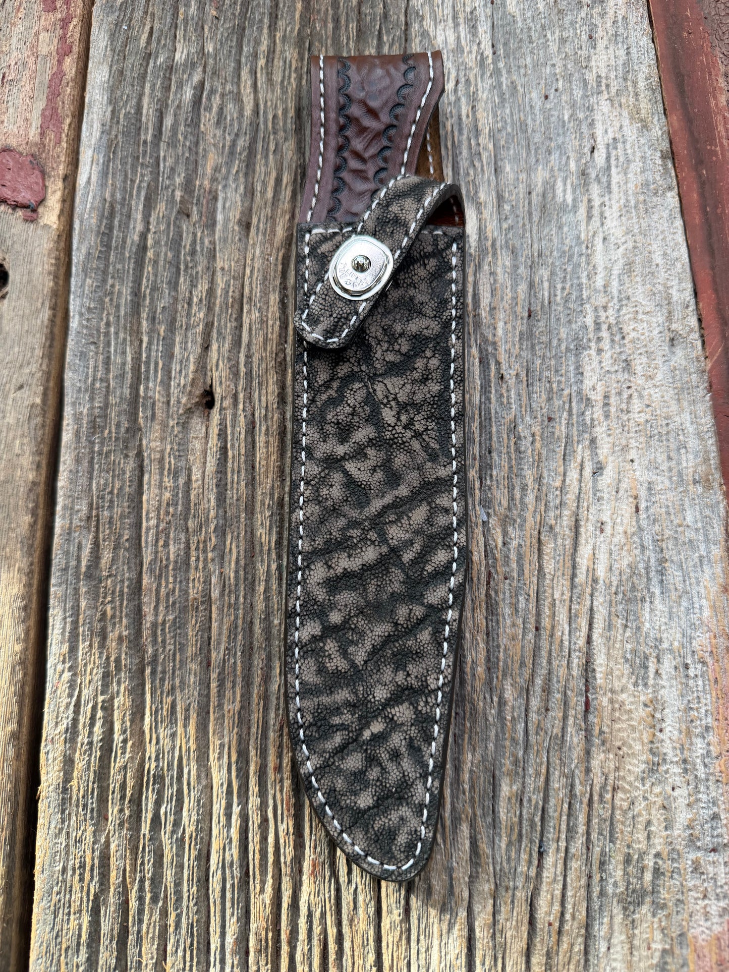 New Randall Model 1-8 Sheath in Exotic thick and textured Black and Grey Elephant Ear  on brown leather from Treeman with a silver Canteen snap. Hand tooled belt loop. Killer sheath.