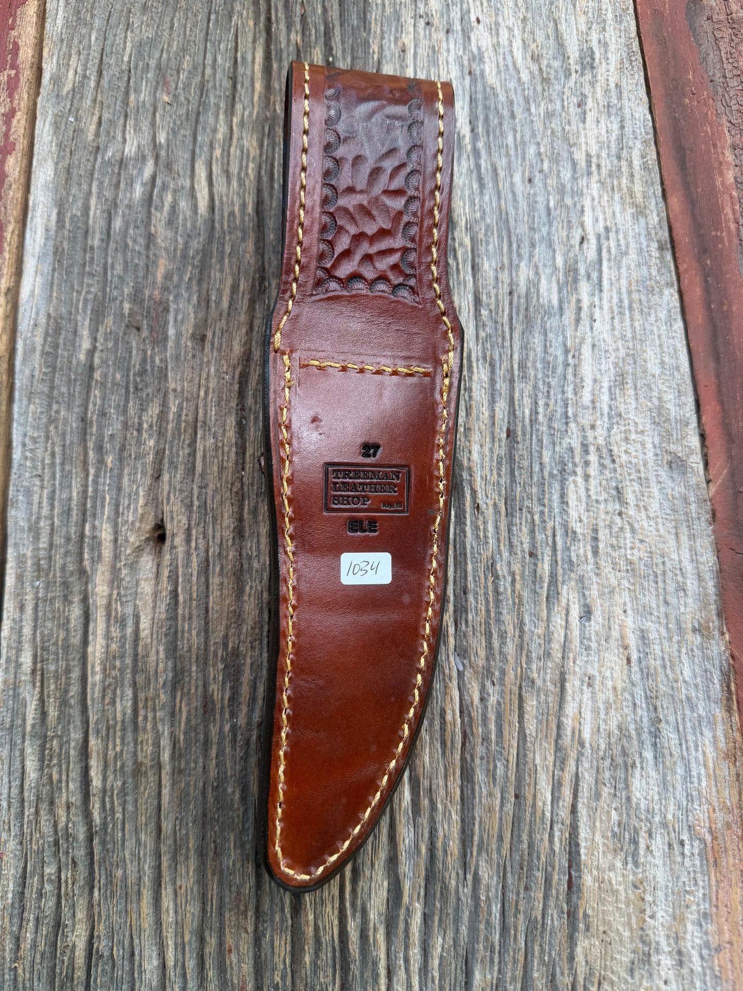 New Randall Model 27 Sheath in Exotic thick and textured Rust colored Elephant hide on brown leather from Treeman with a silver Canteen snap. Hand tooled belt loop. Killer sheath.