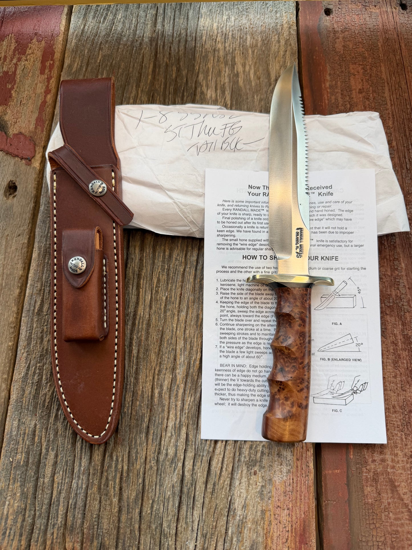 New in Paper Randall Made Knife Model 1-8 in Thuya wood. Stainless, single Black spacer, Sawteeth, Nickel Hilt.