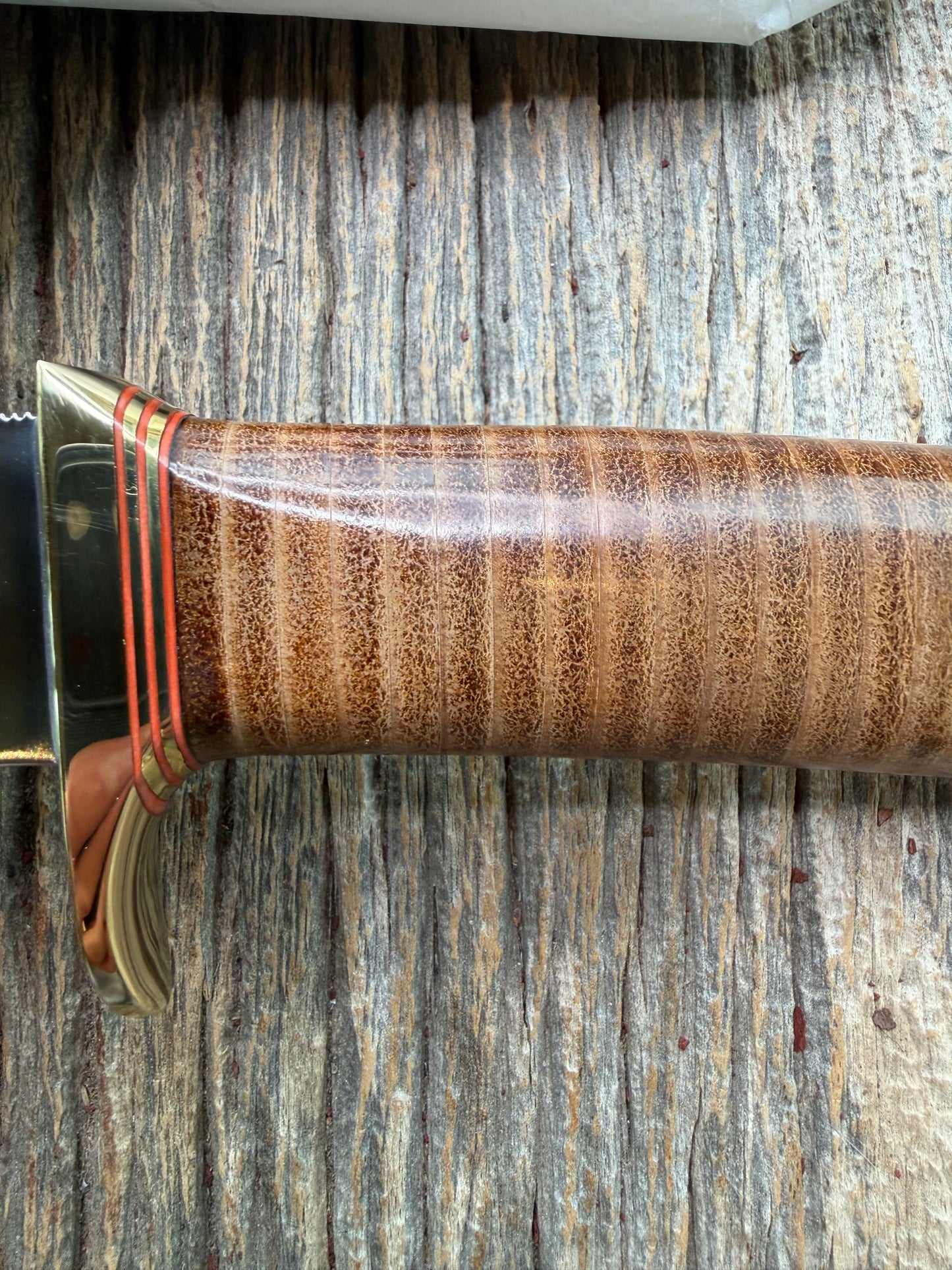 New in Paper Randall Model 19-5 Bushmaster with a Leather handle. Carbon blade, Brass single hilt. Brown leather sheath.