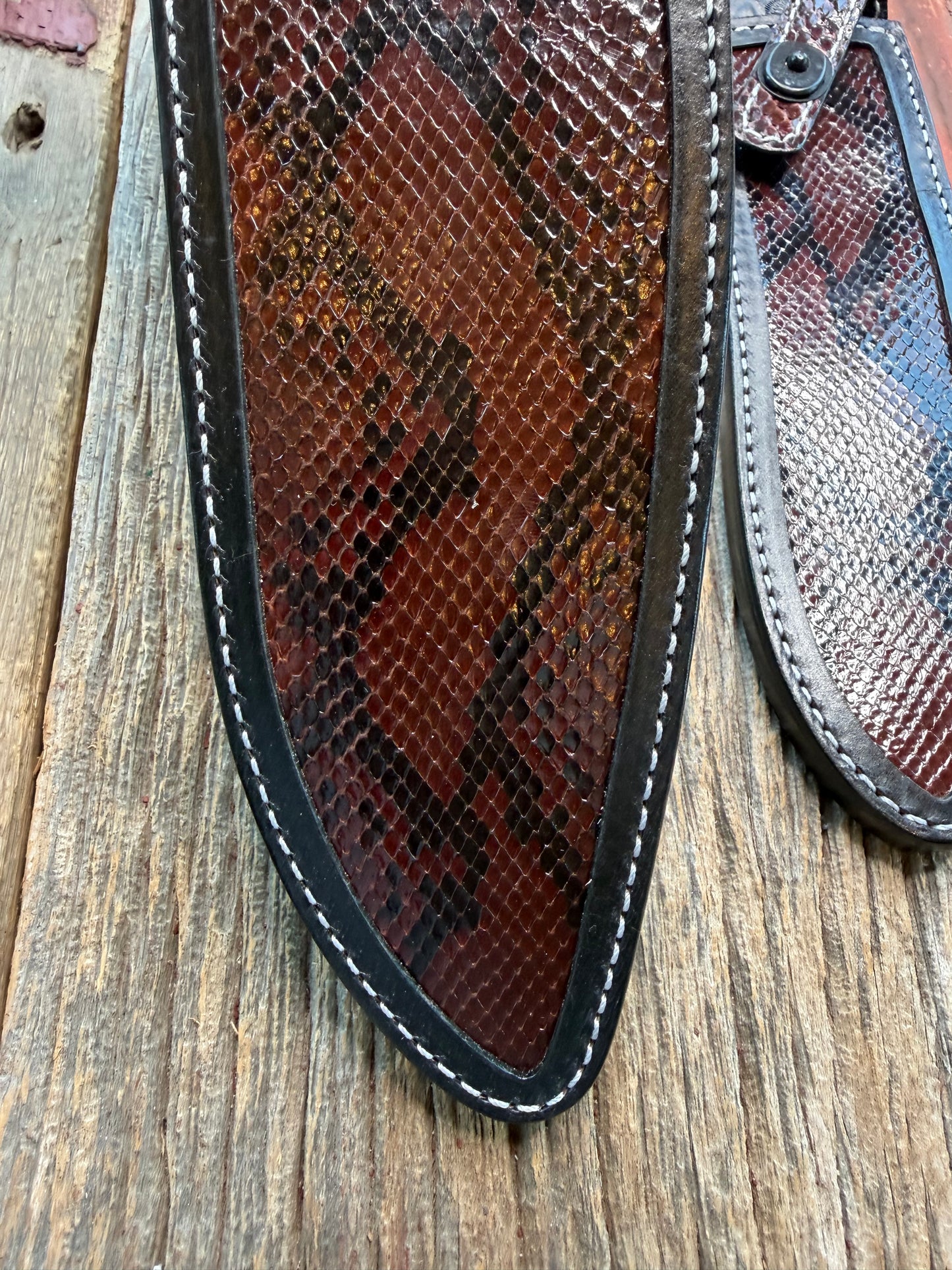 New pair of Randall Model 12-11 Large Sasquatch and 12-8 Small Sasquatch Sheath in Exotic Brown Python Snake on black leather from Treeman with a black Canteen snap. Hand tooled belt loop. Deviated white stitching. Killer sheath.