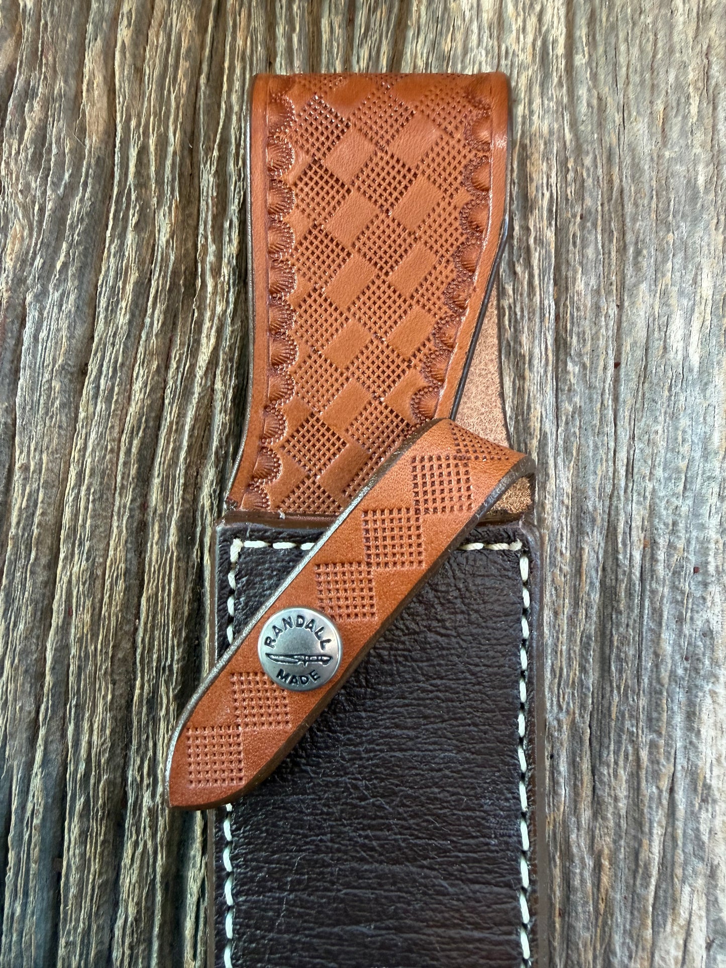 New Randall Model 2-7 Sheath in Exotic Brown Cape Buffalo with full leather hand tooled belt loop. Randall snap and stamp on the back. Custom Made at Sullivan’s by Gutcher