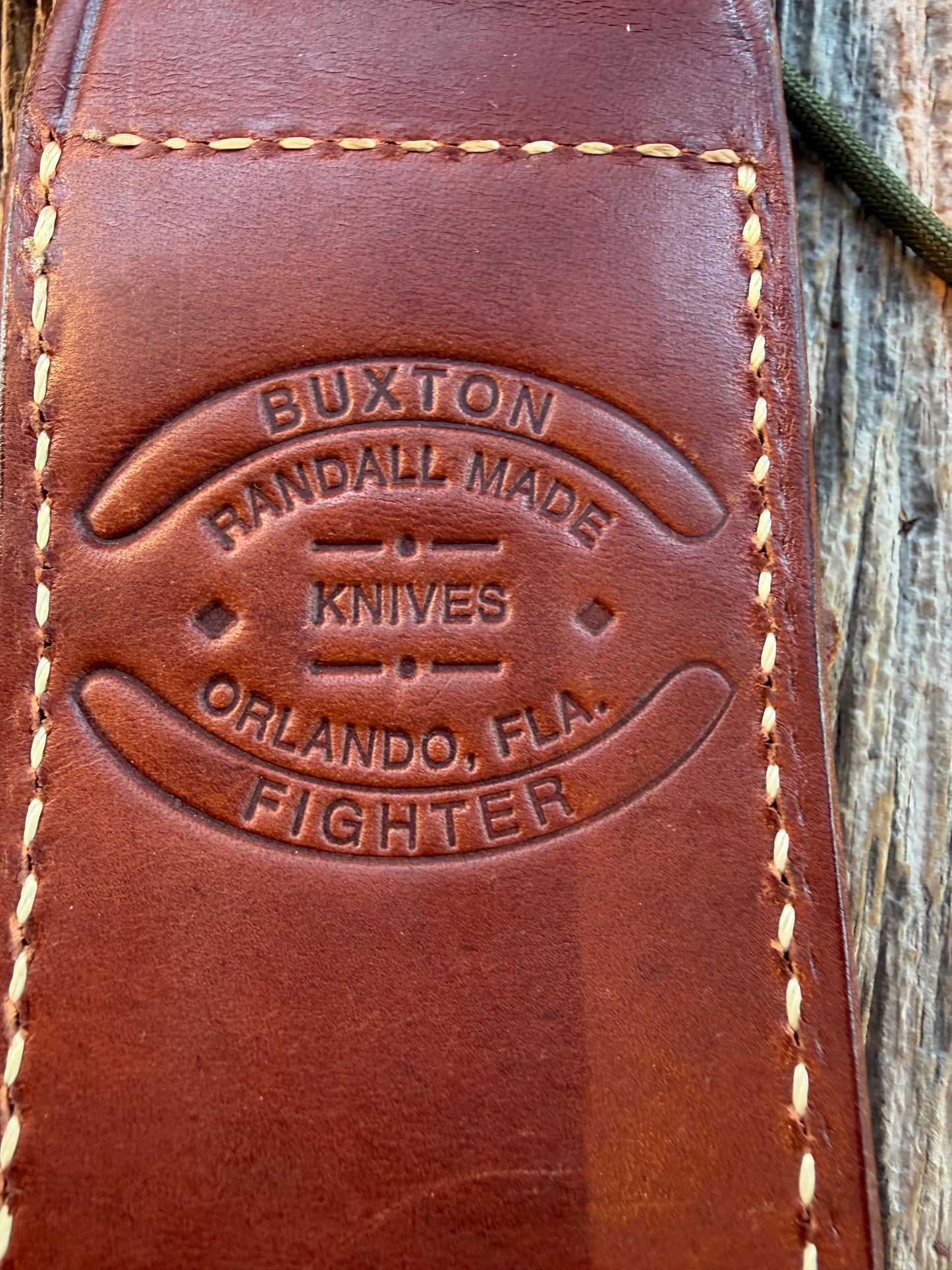 Mint Randall by Gutcher Knife Sheath for a Model Buxton Fighter. Randall snaps, double stitched, pouch with stone, lanyards straps as well.