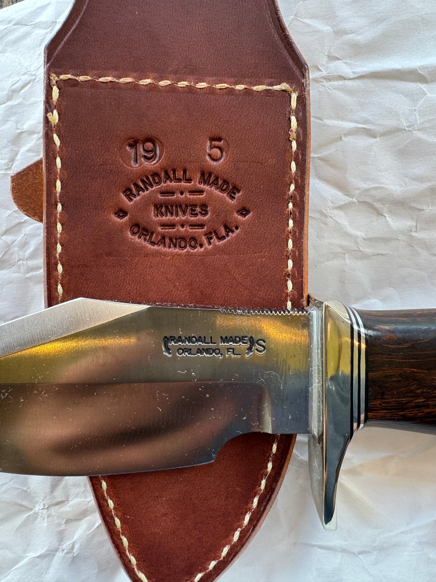 New in Paper Randall Model 19-5 Bushmaster with an Ironwood handle. SS blade, Nickel silver single hilt. Brown leather sheath.