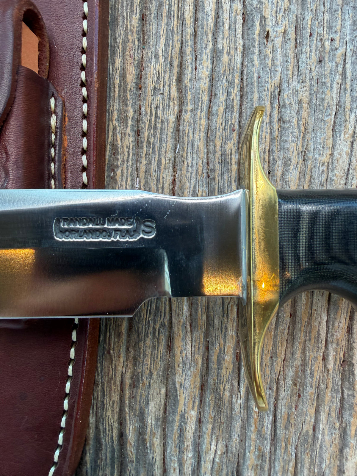 Nice Randall Model 16-7 with a Black  Micarta handle. SS blade, brass hilt. Lanyard. Brown leather sheath.