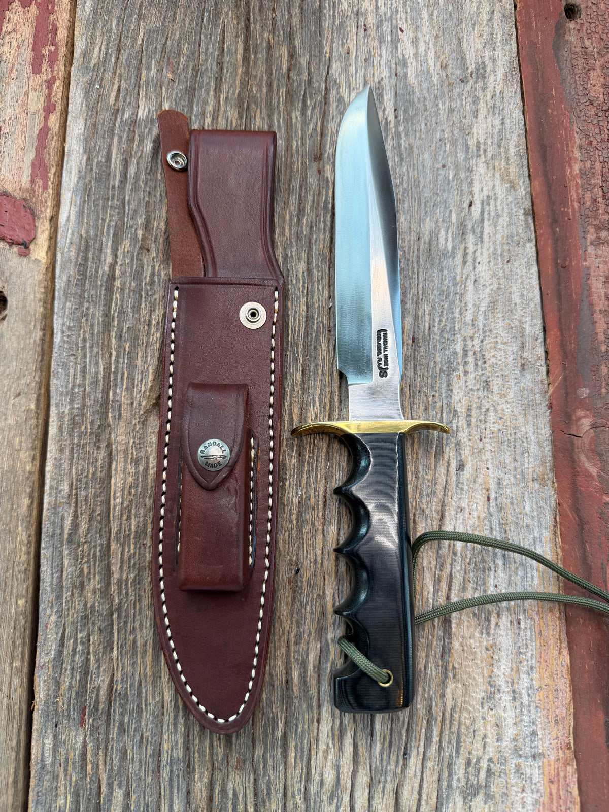Nice Randall Model 16-7 with a Black  Micarta handle. SS blade, brass hilt. Lanyard. Brown leather sheath.