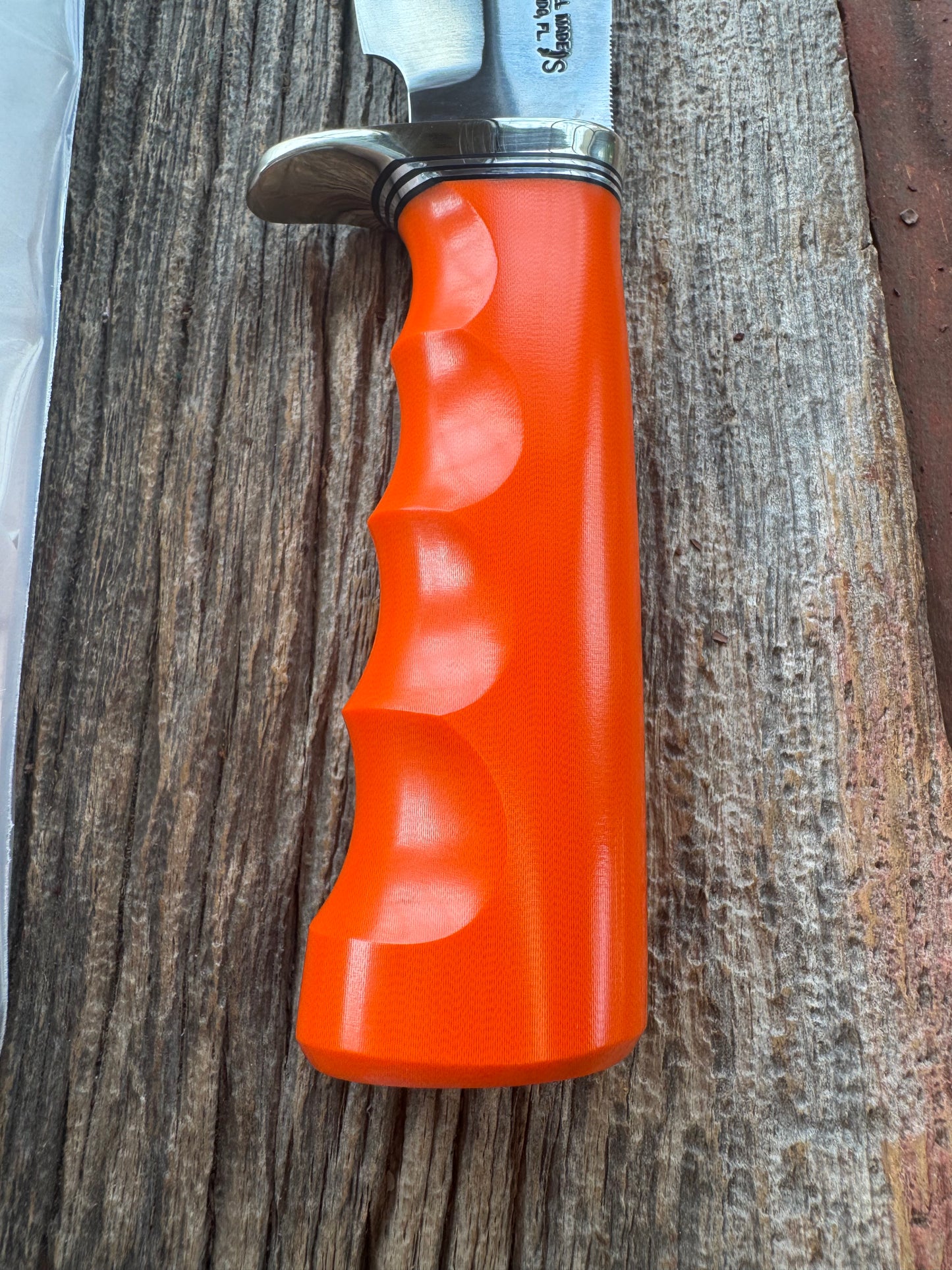 New in paper Randall Model 19-5 with a nice piece of customer supplied Orange G10 with finger grooves. Stainless Steel, Nickel Silver Hilt and a raw natural end.