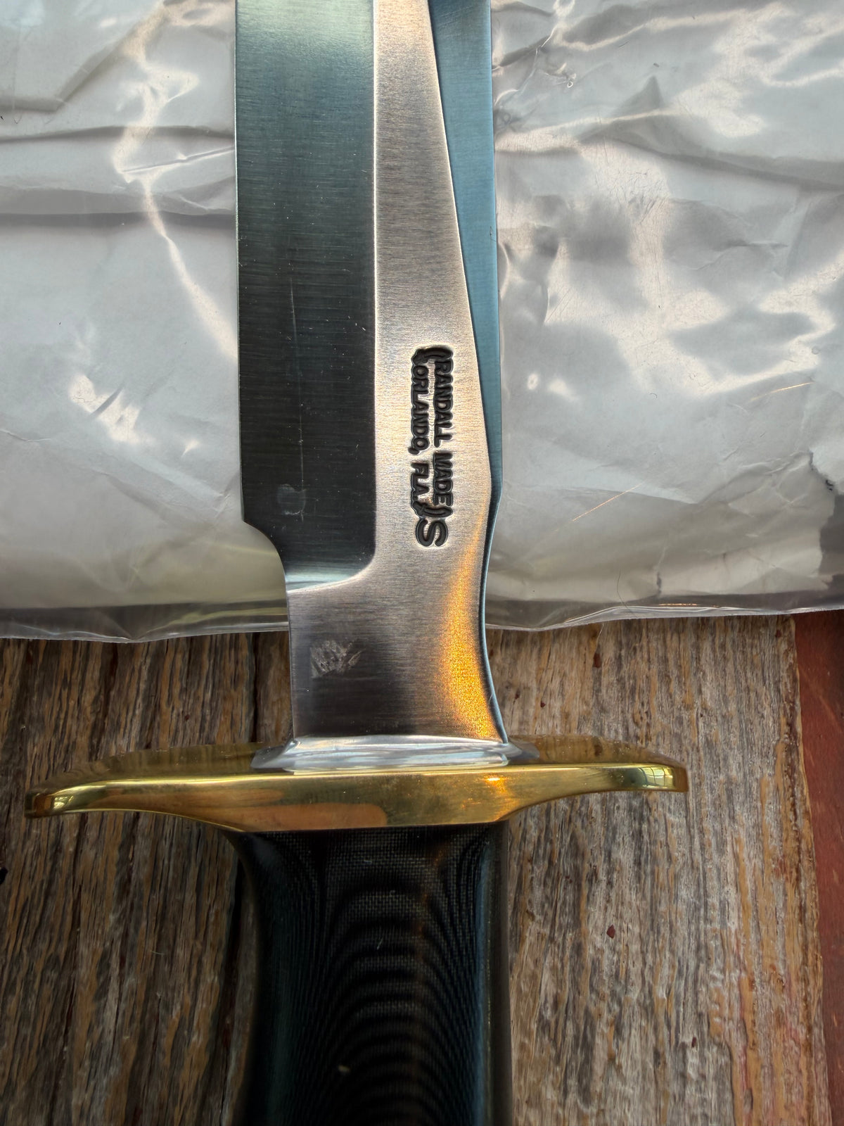 Nice Randall Model 16-7 with a Black  Micarta handle. SS blade, brass hilt. Lanyard. Brown leather sheath.