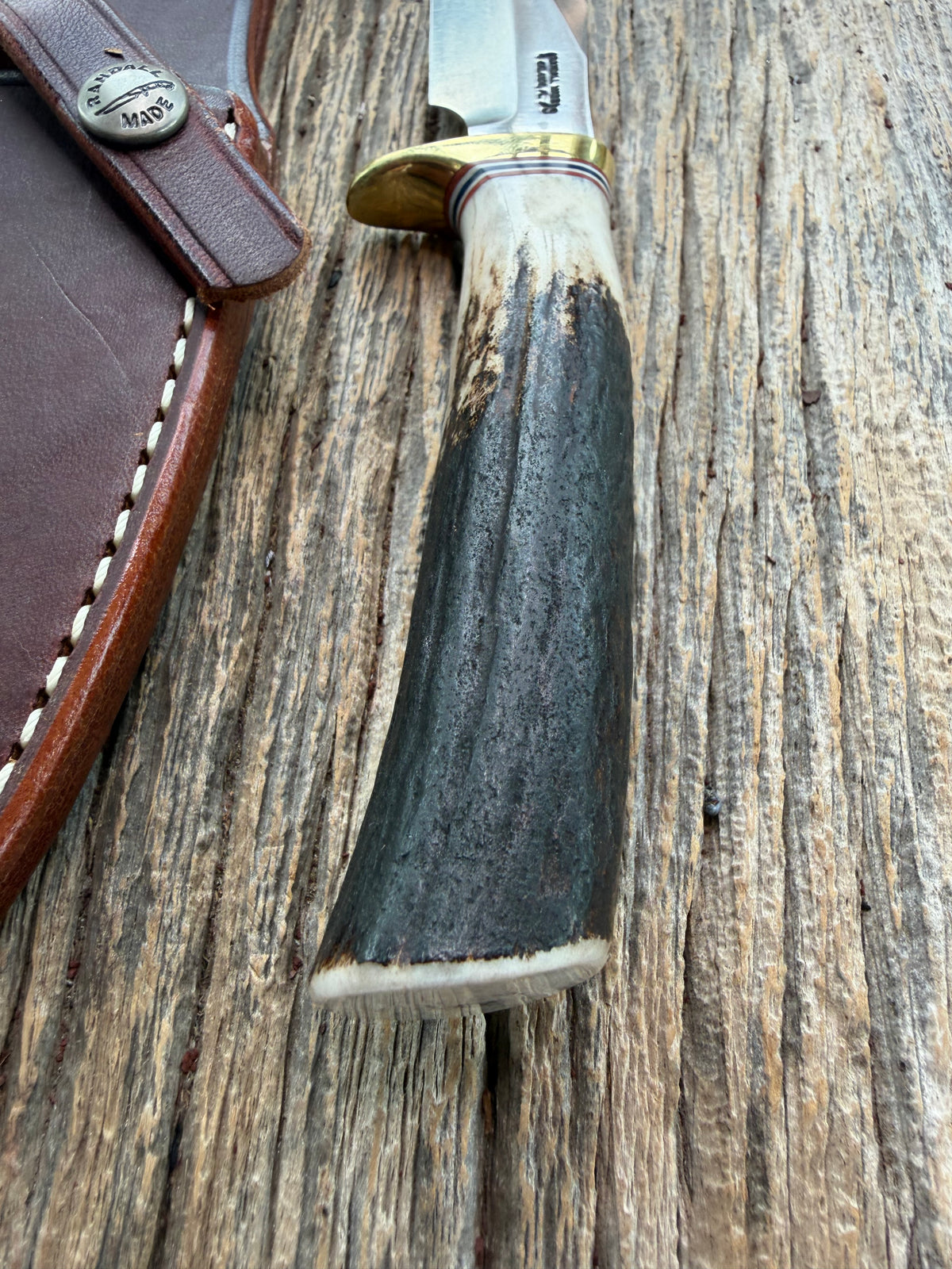 New Randall Model 8-4 with a Stag handle. Stainless steel blade, brass single hilt and natural butt. Red white and Blue spacers.