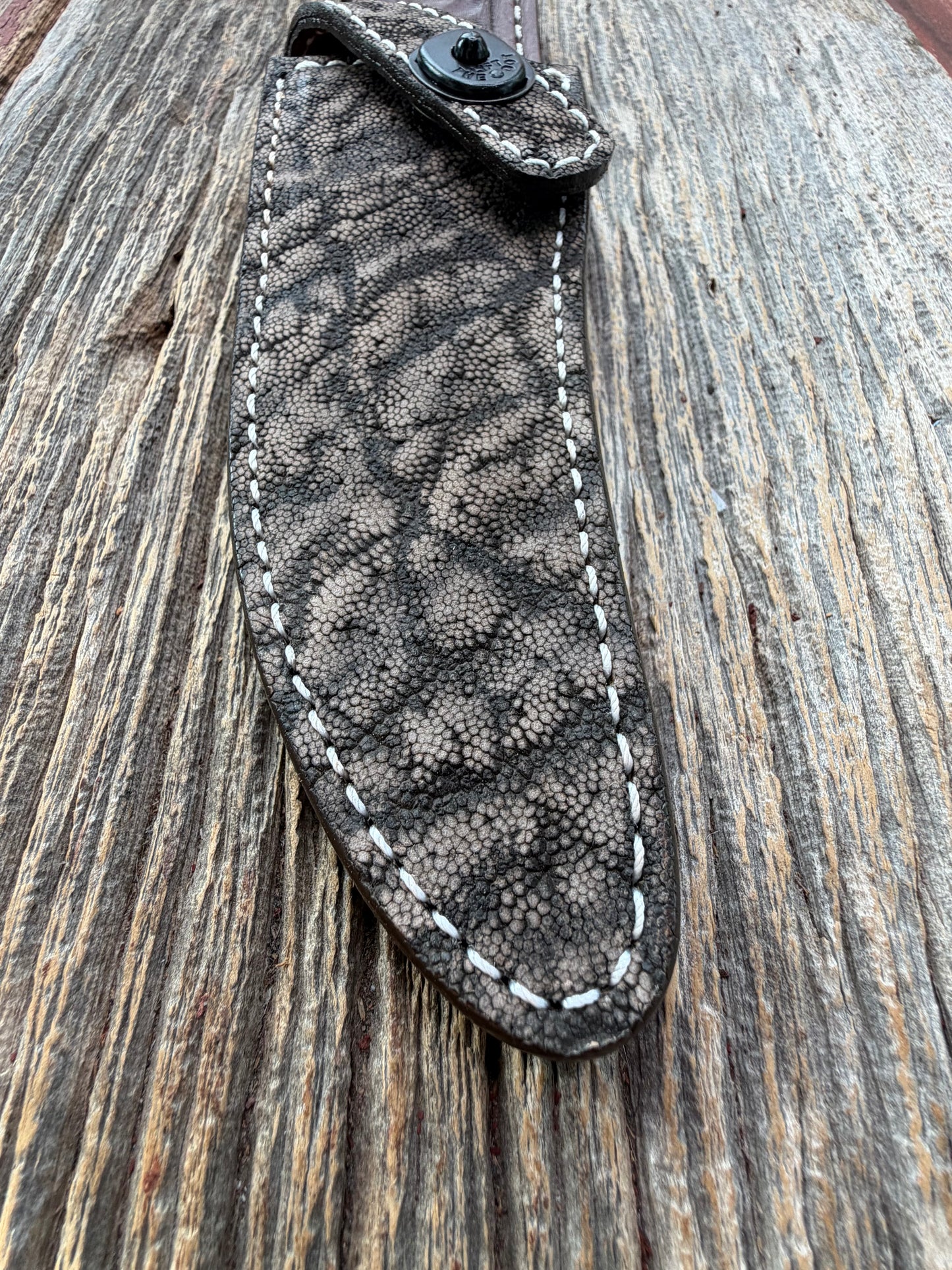 New Randall Model 27 Sheath in Exotic thick and textured Black and Grey Elephant Ear  on brown leather from Treeman with a black Canteen snap. Hand tooled belt loop. Killer sheath.