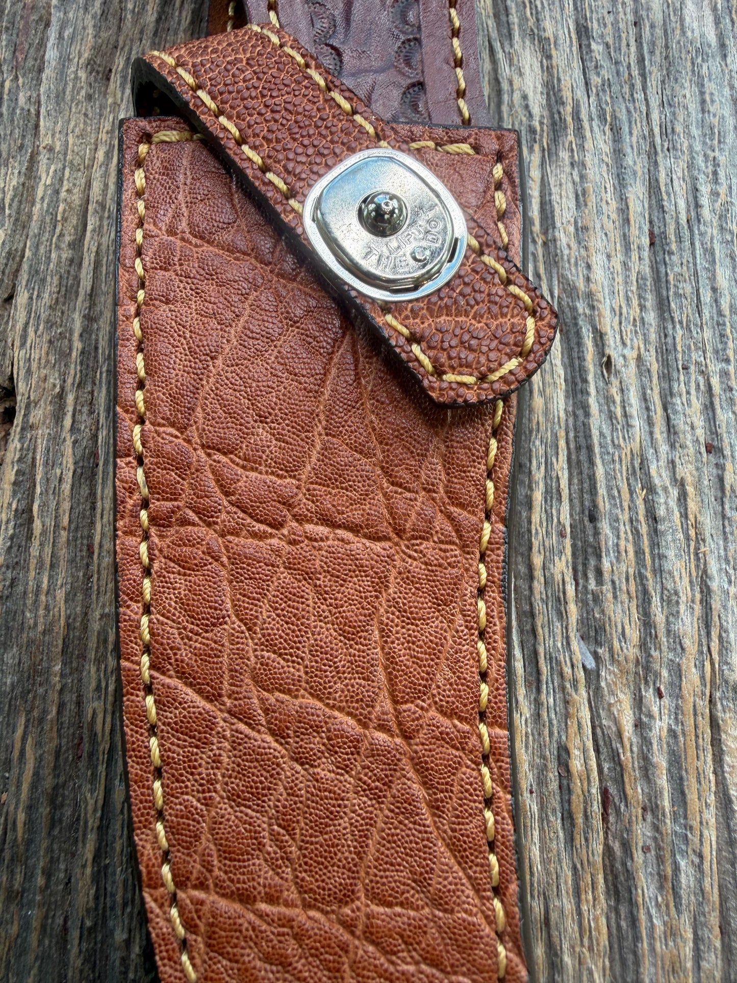 New Randall Model 27 Sheath in Exotic thick and textured Rust colored Elephant hide on brown leather from Treeman with a silver Canteen snap. Hand tooled belt loop. Killer sheath.
