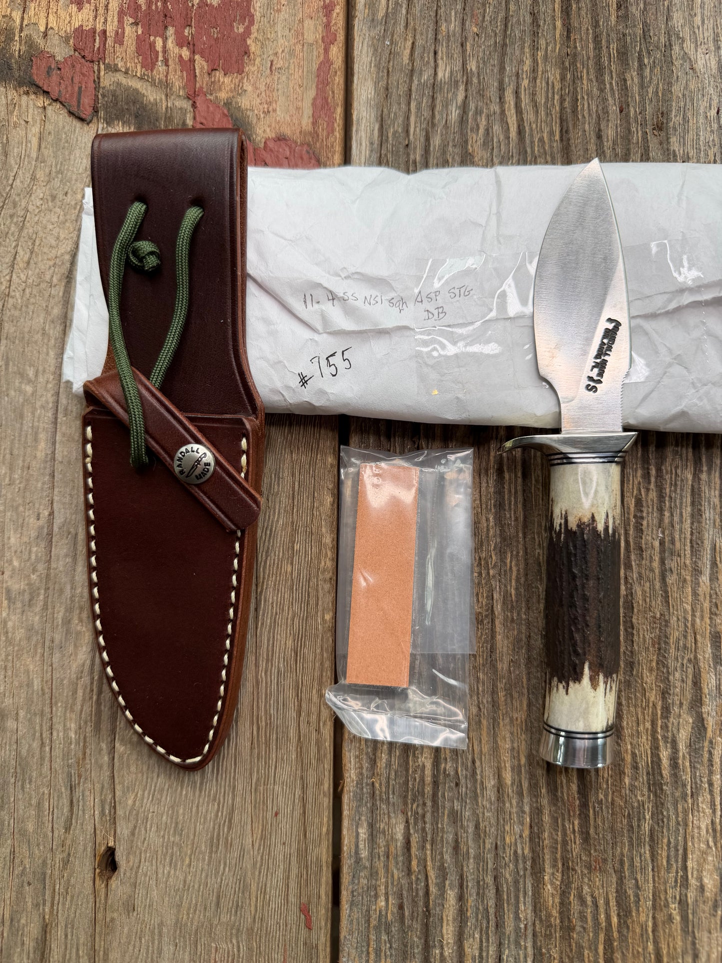 New in Paper Randall Made Knife Model 11-4 with a Stag handle, Stainless, Nickel silver single Hilt, Black and aluminum spacers.