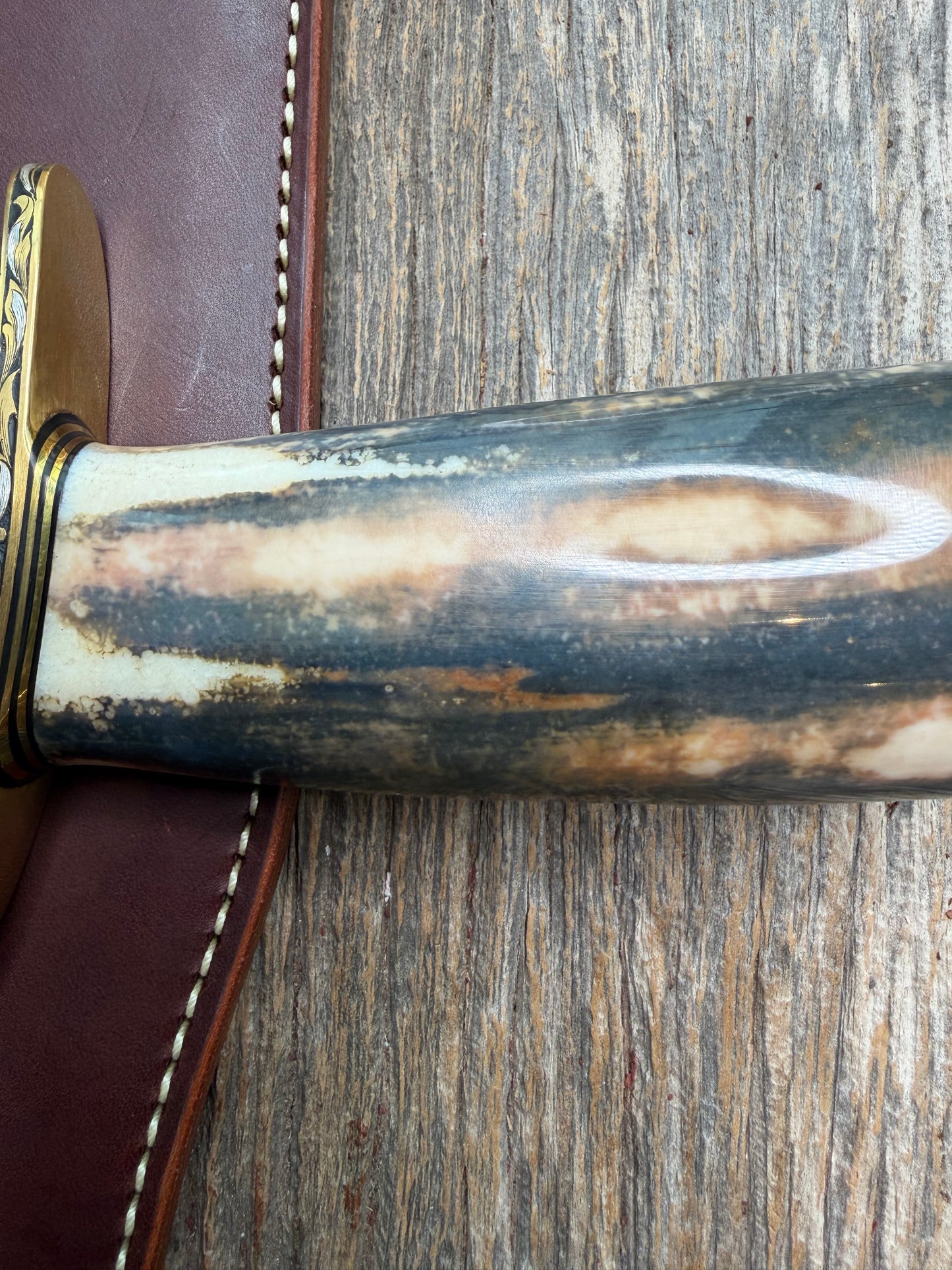 Randall Model 12-11 Smithsonian “Smitty” in a Huge piece of Green, Brown and Blue Fossil Walrus Ivory. Brass Hilt and Brass Butt plate fully engraved in Silver from Jere Davidson.  Stunning piece.