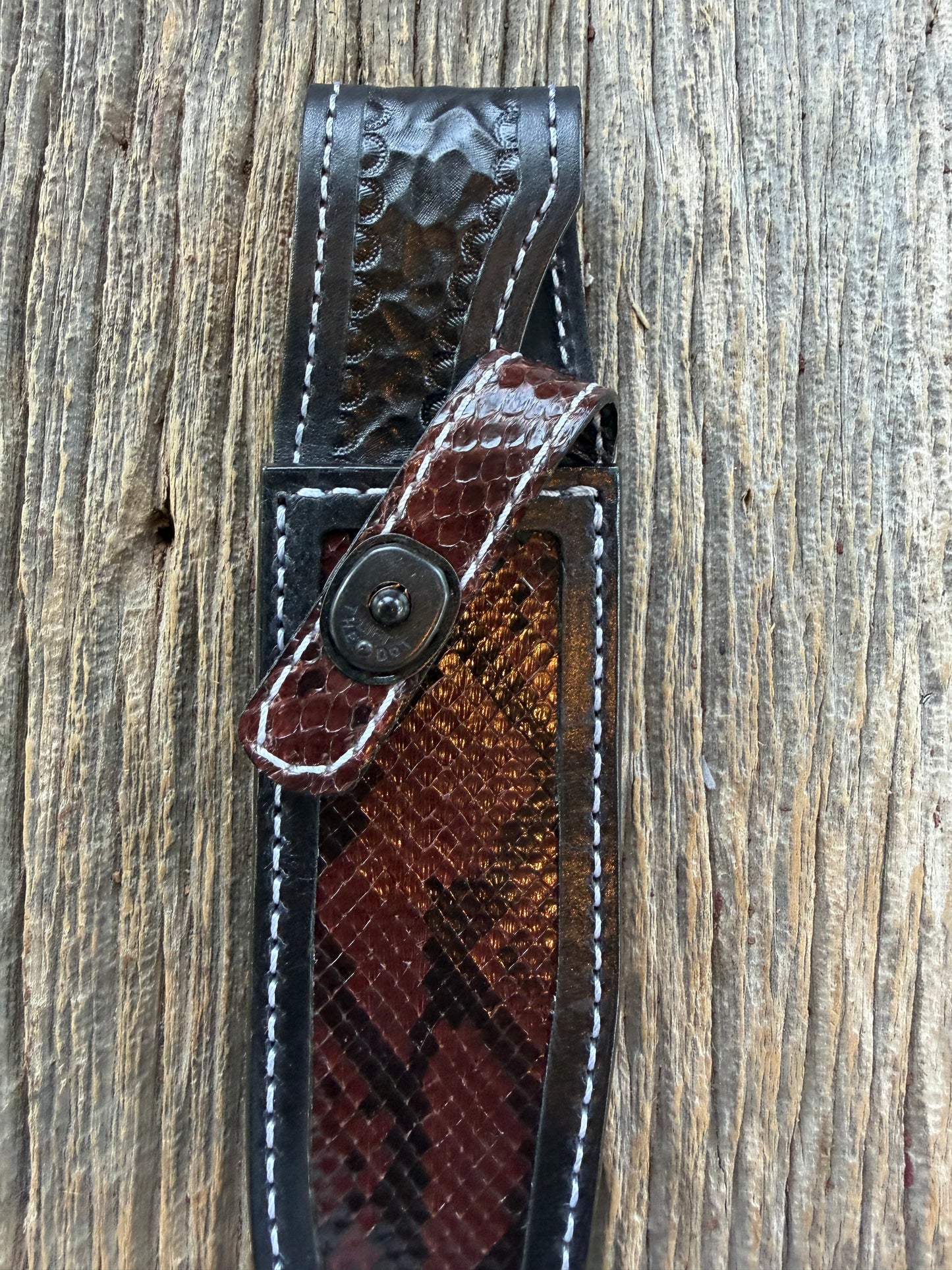 New Randall Model 1-6 Sheath in Exotic Brown Python Snake skin on black leather from Treeman with a black Canteen snap. Hand tooled belt loop. Deviated white stitching. Killer sheath.