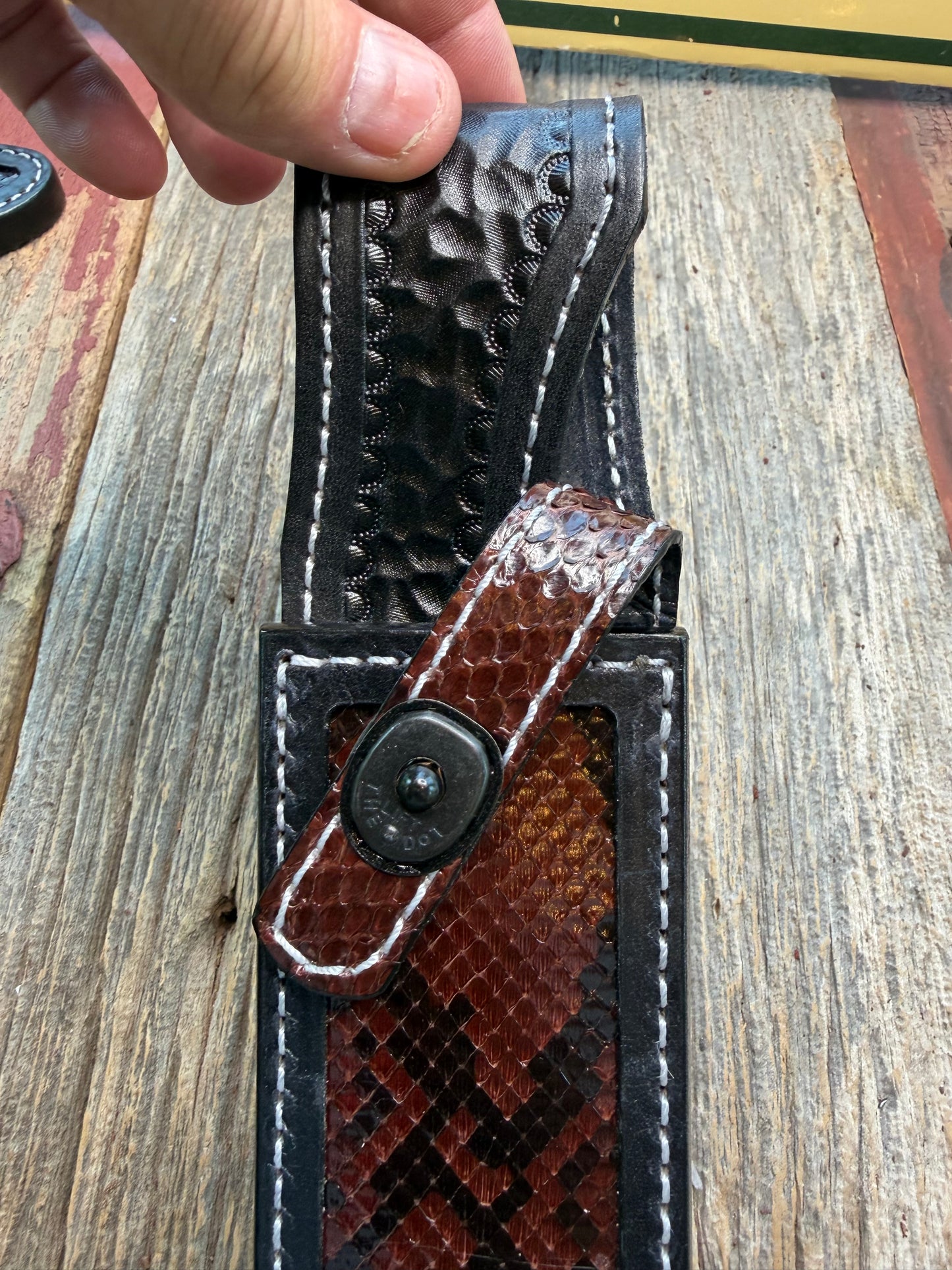 New Randall Model 1-8 Sheath in Exotic Brown Python Snake skin on black leather from Treeman with a black Canteen snap. Hand tooled belt loop. Deviated white stitching. Killer sheath.