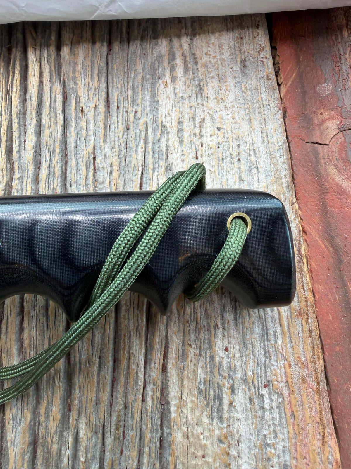 Randall Model 14-7.5 with a Black Micarta finger grooved handle. Stainless steel blade, brass double hilt brown leather sheath, Lanyard.