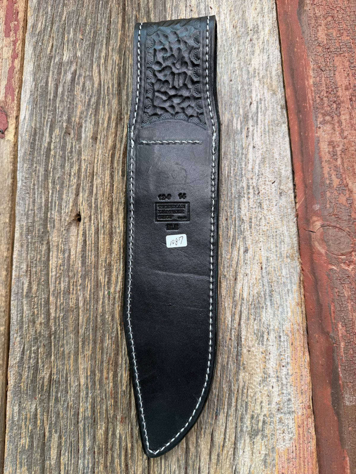 New Randall Model 12-9 Sheath in Exotic Black Matte Elephant Hide from Treeman with a Black Canteen snap. White thread deviated stitching on black leather..Killer sheath.