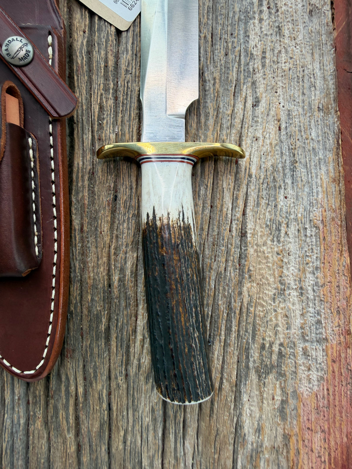 New Randall Model 1-6 with a Stag handle. Stainless steel blade, brass hilt and natural butt. Red white and Blue spacers.