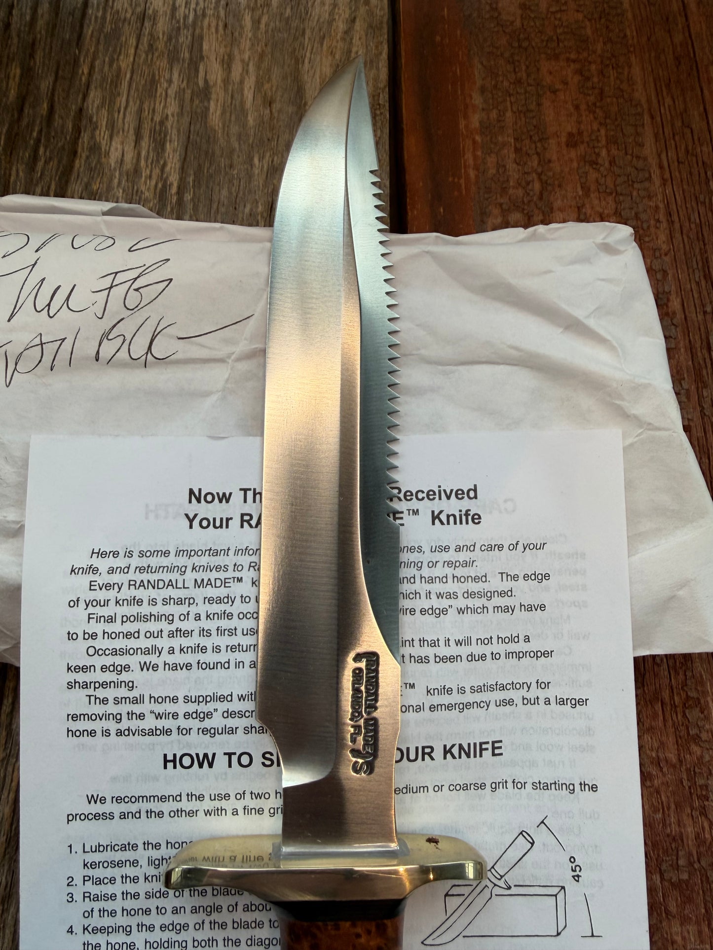 New in Paper Randall Made Knife Model 1-8 in Thuya wood. Stainless, single Black spacer, Sawteeth, Nickel Hilt.