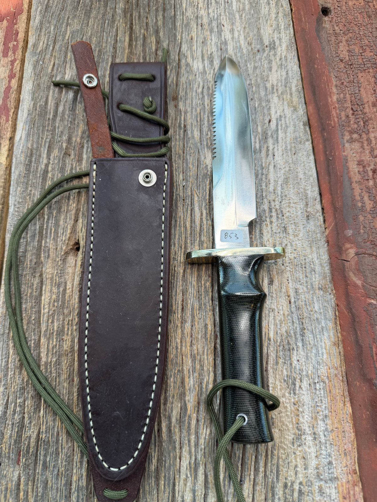Nice Randall Model 16-7 with a glossy Brown Micarta handle. SS blade, double nickel silver hilt. Lanyard. Sawteeth, Brown waxed leather sheath.