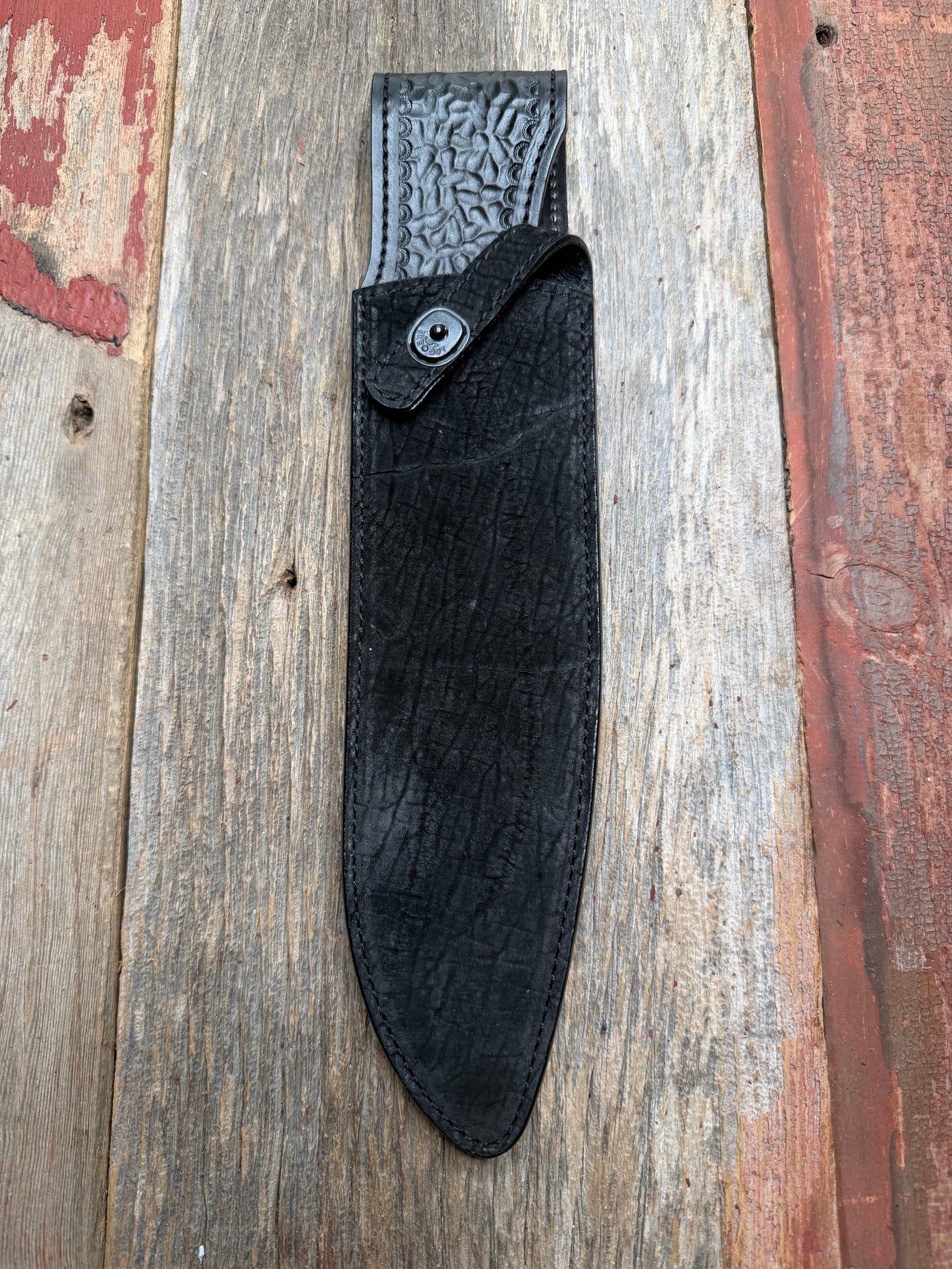 Randall Model 12-11 Large Sasquatch in Black Hippo, forward curved hilt, black Canteen Snap, full brass stamping and stitching.