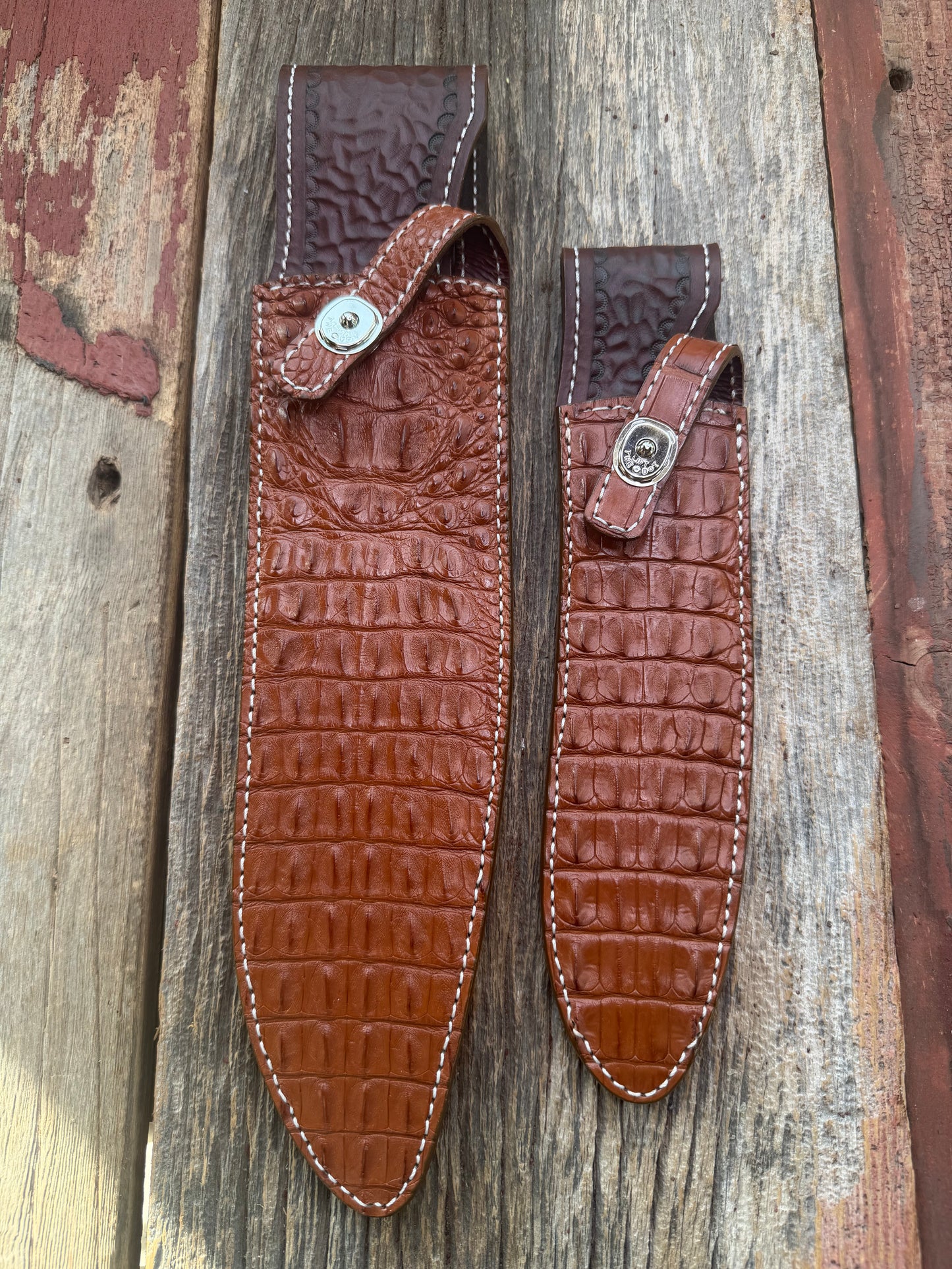 Pair of new Randall Model 12-11 Large and Small Sasquatch Sheaths in Exotic thick and textured Honey Crocodile skin ( skull portion) on brown leather from Treeman with a silver Canteen snap. Hand tooled belt loop. Killer sheath.