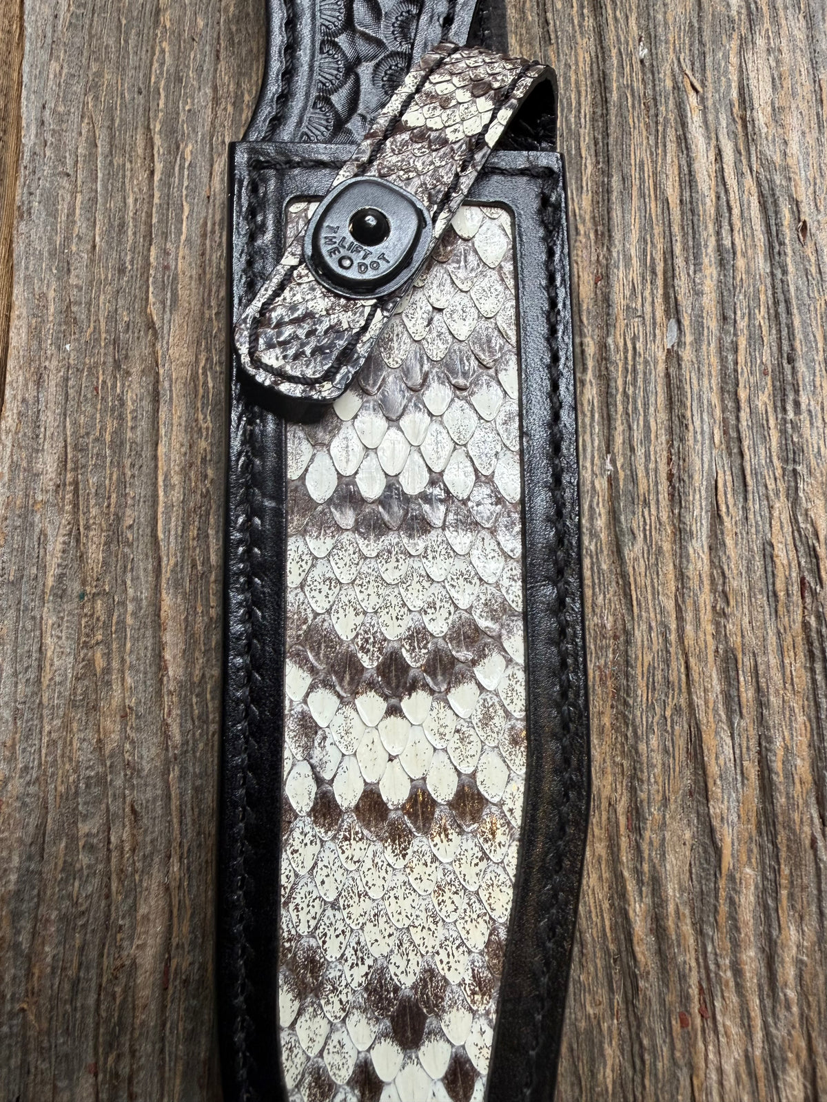 Randall Model 1-7 sheath with an Eastern Diamondback RattleSnake skin from Treeman Sheaths. Hand tooled belt loop, canteen snap. One the hardest skins to source.