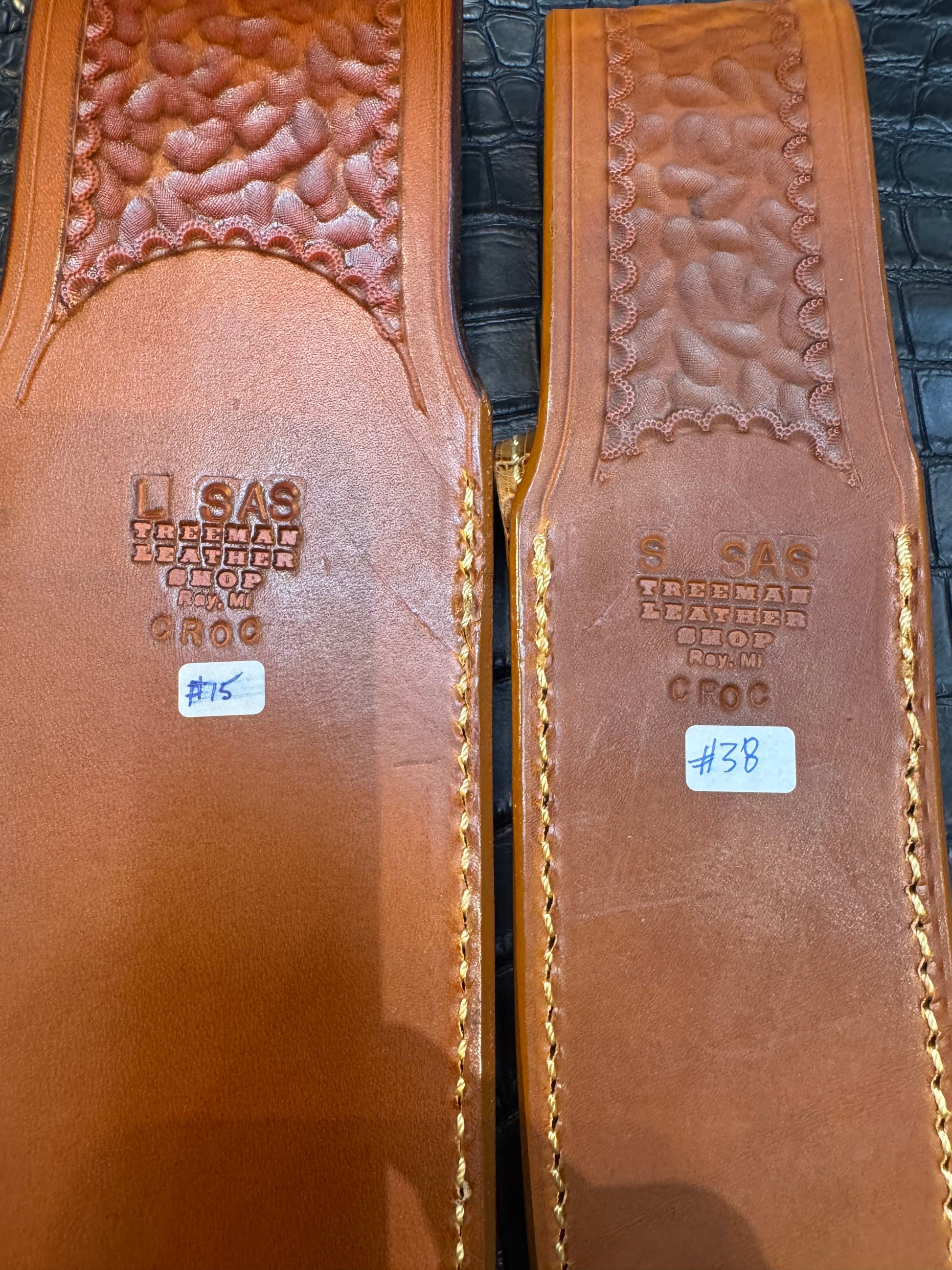 A pair of Randall Model 12-11 Large Sasquatch (Tail) and Randall Model 12-8 Small Sasquatch (Skull) Sheaths in Exotic Tan Hornback Crocodile by Treeman.