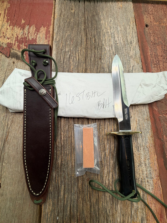 New in Paper Randall Model 16-7 Diver with a Black Micarta handle. SS blade, Brass hilt, Sawteeth, Lanyard, Brown leather waxed sheath.