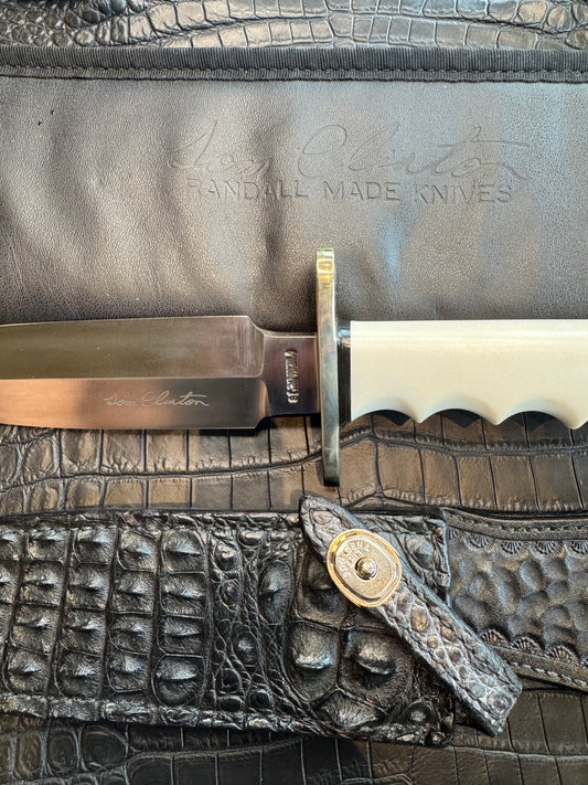 Randall Tom Clinton Dealer Special. Clinton Blade etched Commemorative 1/100 in a nice piece of finger grooved Ivorite. Very cool Black Crocodile skull Gutcher sheath. Nickel Silver Hilt. Included in black facsimile Tom Clinton case.