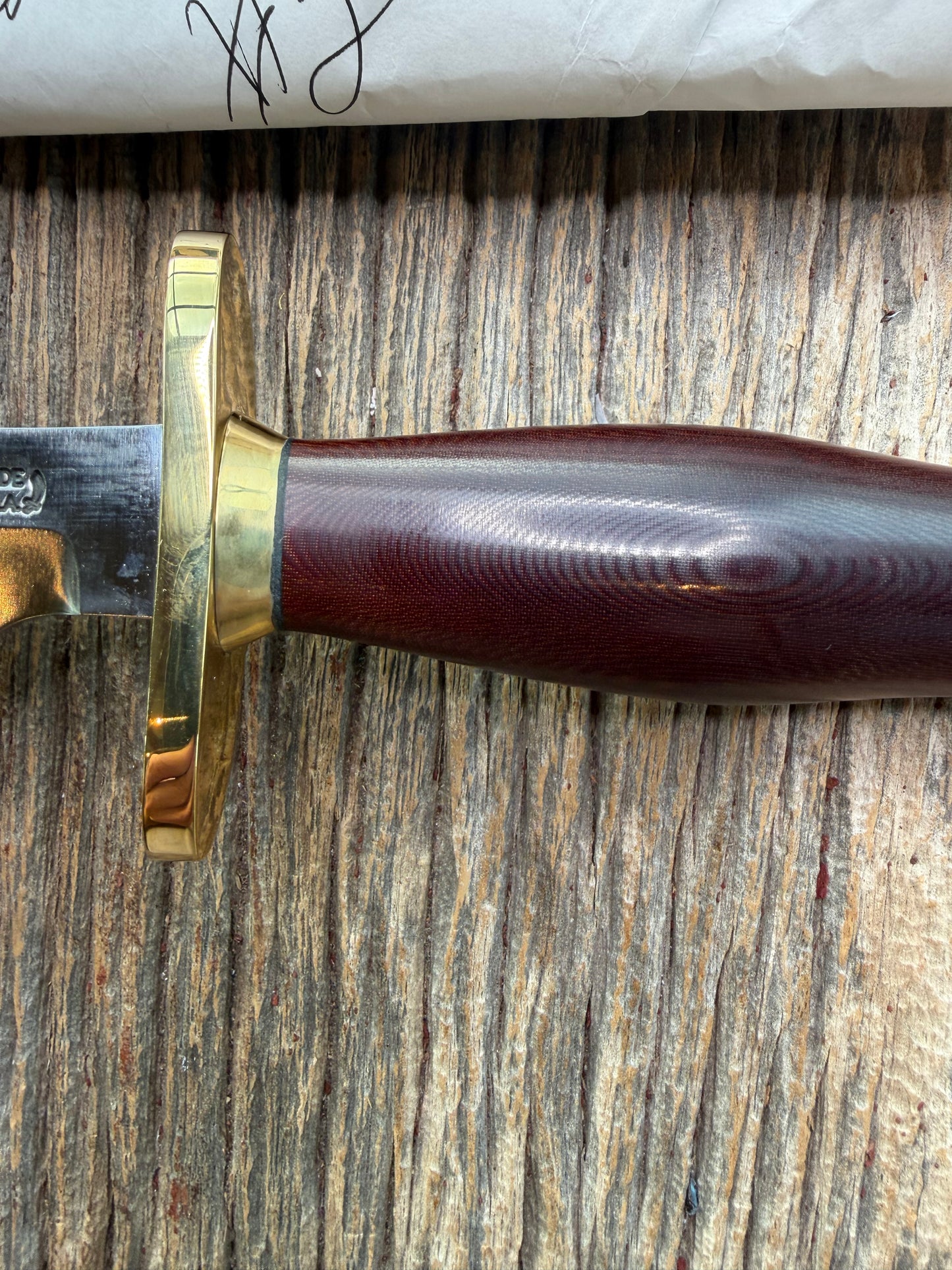 New in Paper Randall Model 12-6 Little Bear with a Maroon Micarta handle. Brass Hilt  and Brass collar Carbon steel, natural end.