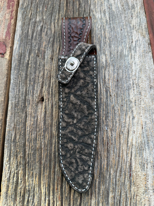 New Randall Model 1-7 Sheath in Exotic thick and textured Black and Grey Elephant Ear  on brown leather from Treeman with a silver Canteen snap. Hand tooled belt loop. Killer sheath.