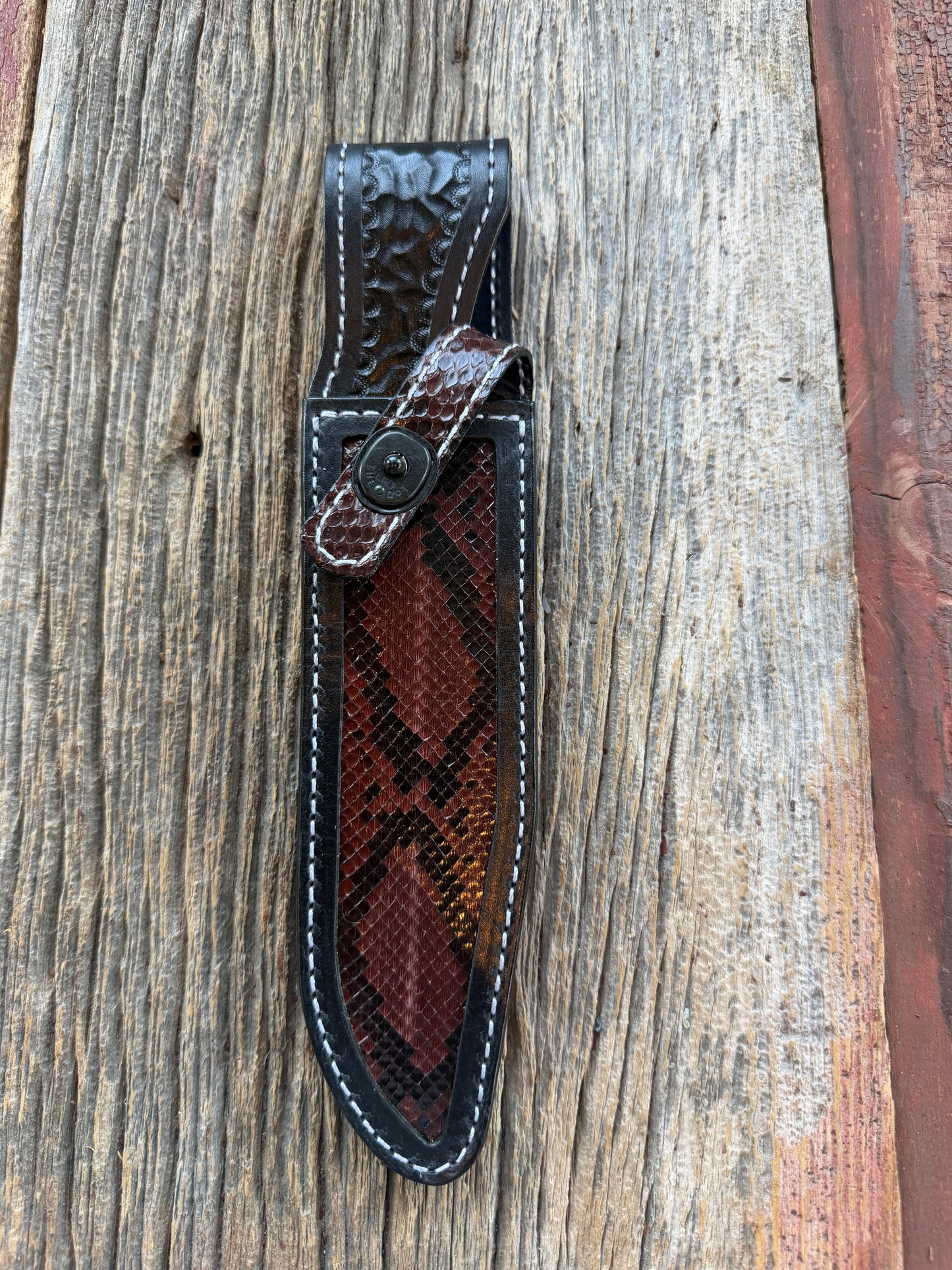 New Randall Model 1-7 Sheath in Exotic Brown Python Snake skin on black leather from Treeman with a black Canteen snap. Hand tooled belt loop. Deviated white stitching. Killer sheath.
