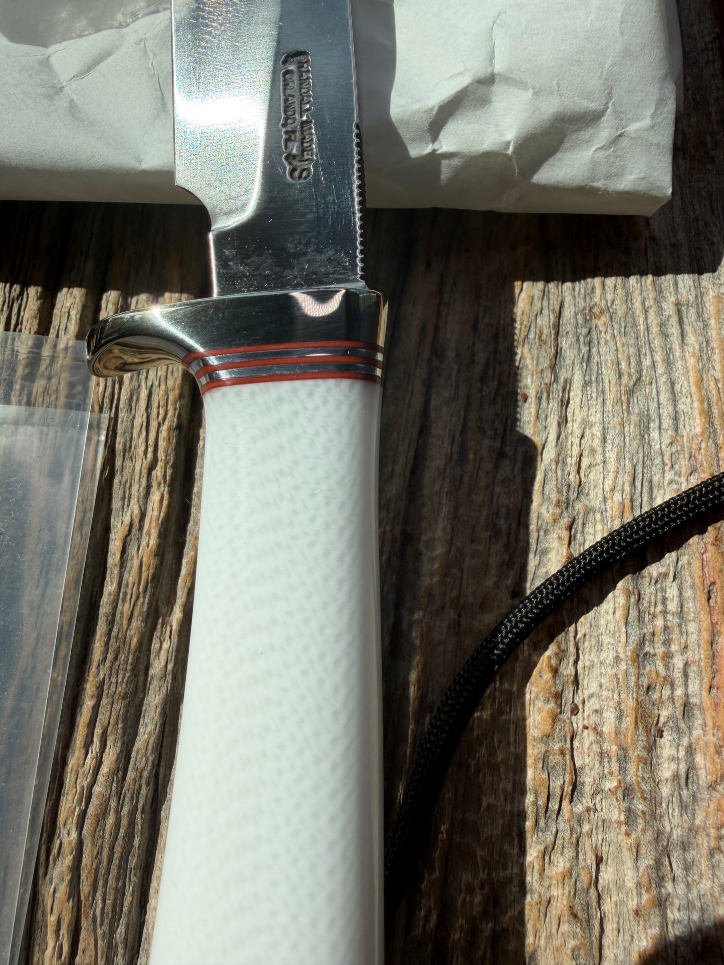 New in Paper Randall Non Catalog Model  Cattleman. White Ivorite handle. Red and silver spacers. Stainless blade.