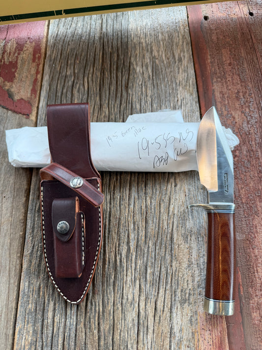 New in Paper Randall Model 19-5 Bushmaster with an Brown Micarta handle. SS blade, Nickel silver single hilt. Lanyard. Brown leather sheath.