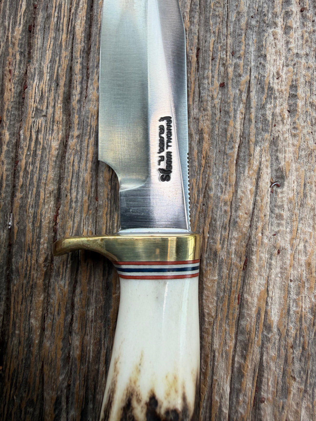 New Randall Model 5-4 with a Stag handle. Stainless steel blade, brass single hilt and natural butt. Red white and Blue spacers.