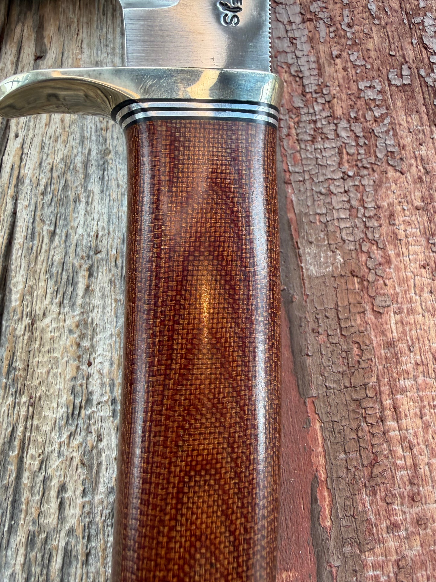 New in Paper Randall Model 19-5 Bushmaster with an Brown Micarta handle. SS blade, Nickel silver single hilt. Lanyard. Brown leather sheath.