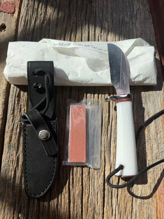 New in Paper Randall Non Catalog Model  Cattleman. White Ivorite handle. Red and silver spacers. Stainless blade.