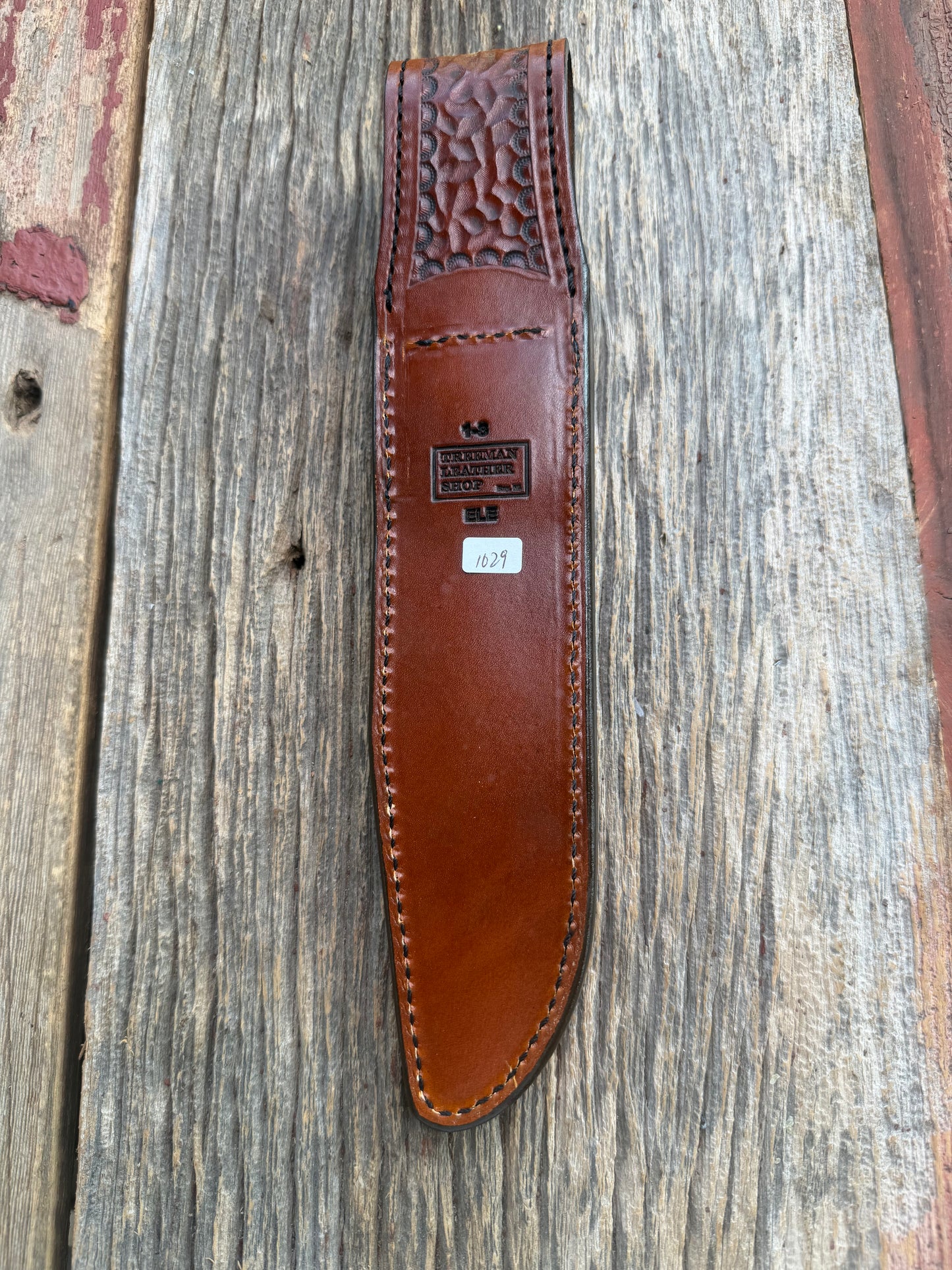 New Randall Model 1-8 Sheath in Exotic thick and textured Rust colored Elephant hide on brown leather from Treeman with a black Canteen snap. Hand tooled belt loop. Killer sheath.