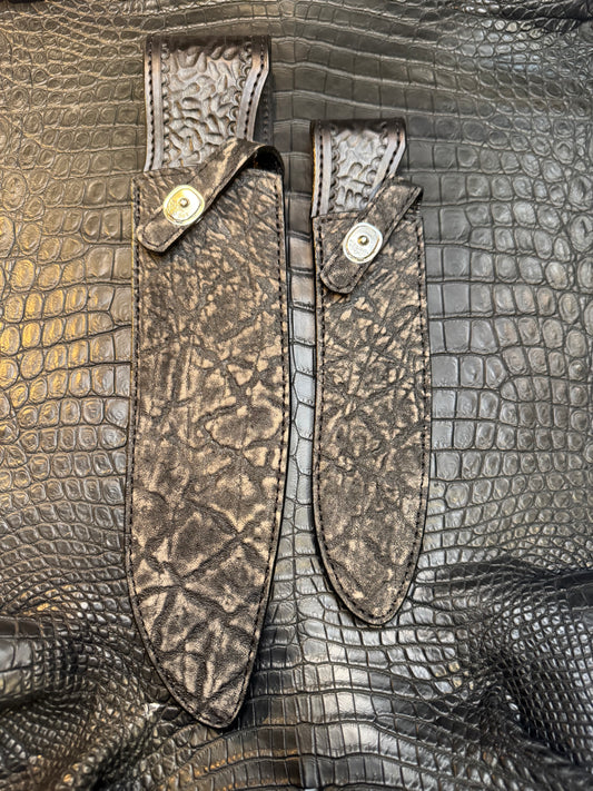 A pair of Randall Model 12-11 Large Sasquatch and Randall Model 12-8 Small Sasquatch Sheaths in Exotic Black Elephant by Treeman.
