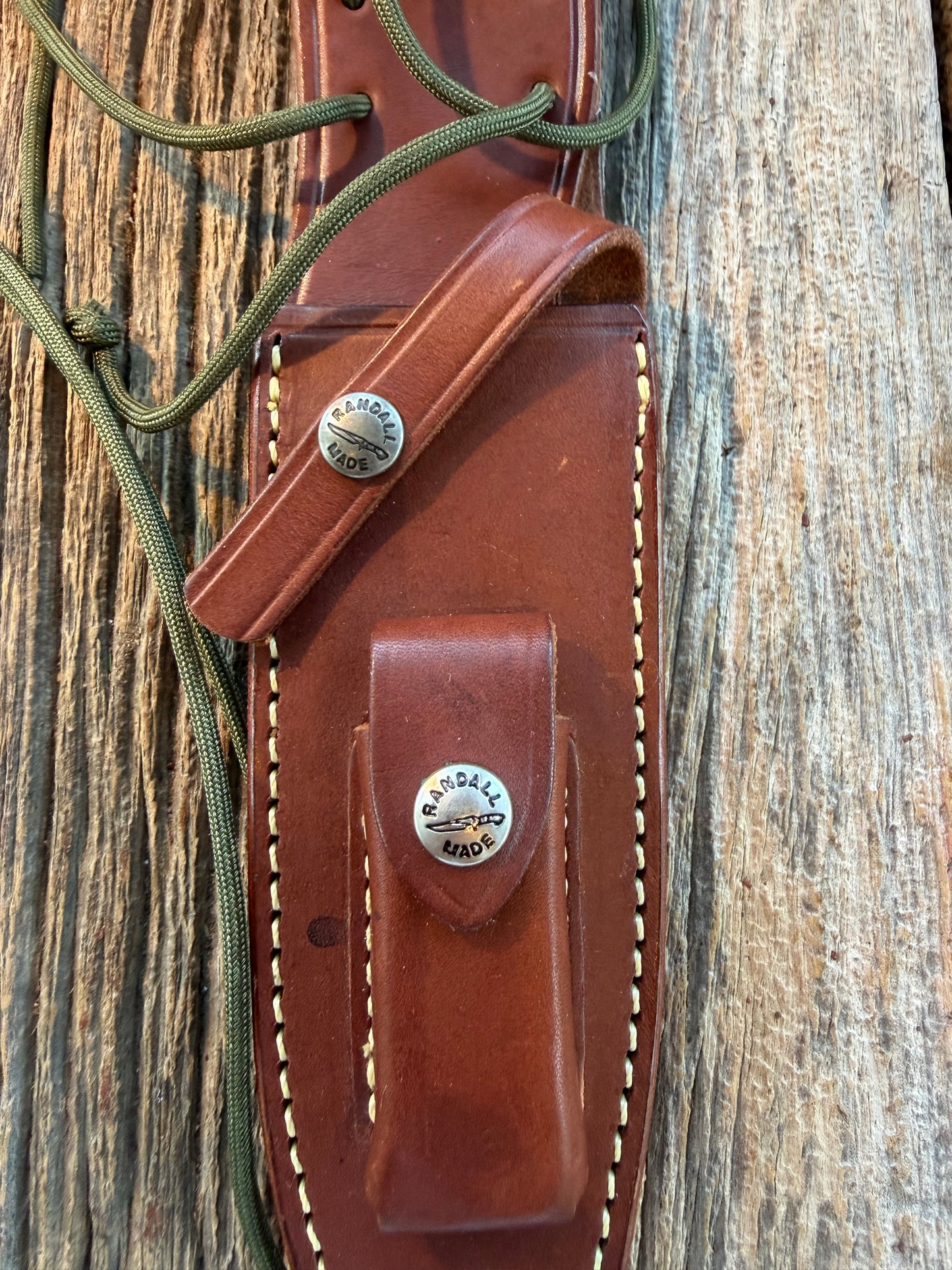 Mint Randall by Gutcher Knife Sheath for a Model Buxton Fighter. Randall snaps, double stitched, pouch with stone, lanyards straps as well.