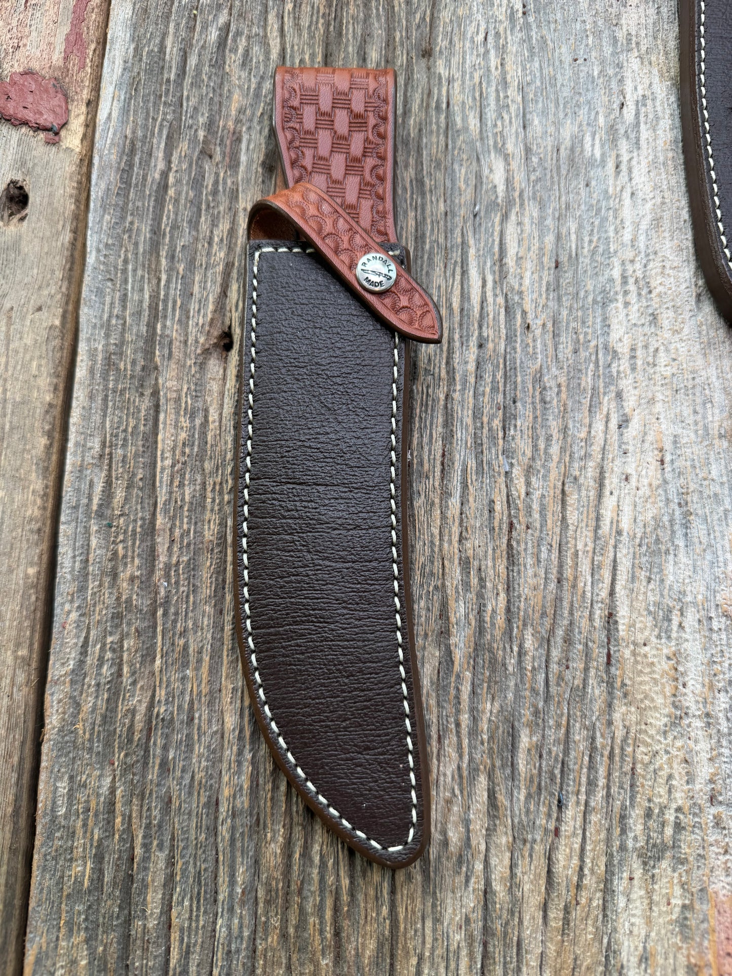 Pristine Randall Model 4-7 sheath in Exotic Cape Buffalo leather from Sullivans by Gutcher. Heavily tooled belt loop and strap. Randall snap and clean stamping on the back … perfect!!
